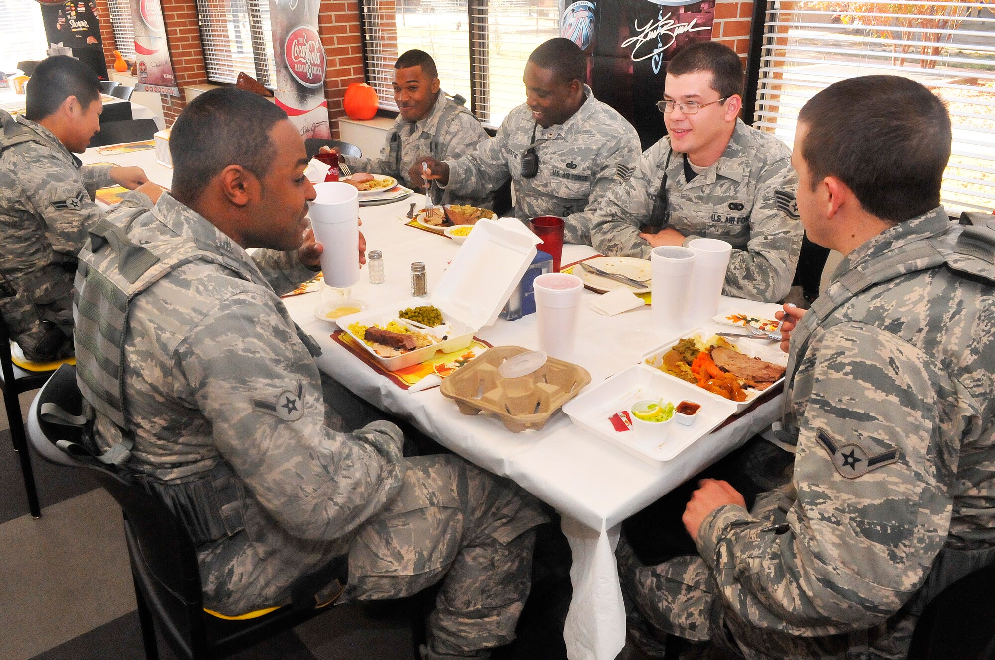 Airmen with the 78th Air Base Wing Security Forces Squadron take a break to enjoy some food and fellowship during the Thanksgiving meal at Wynn Dining facility.  (U. S. Air Force photo/Sue Sapp)
