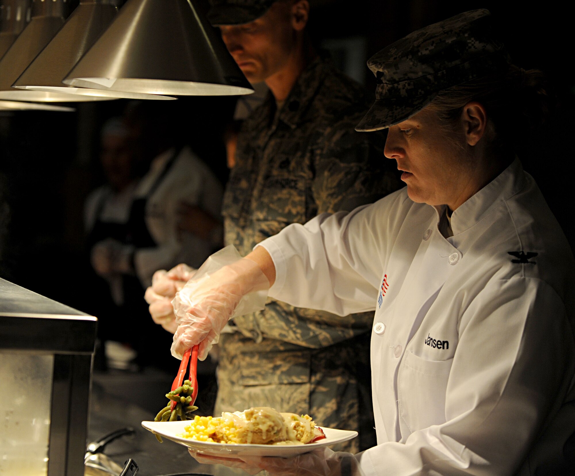 U.S. Army Col. Jayne Jansen, 633rd Air Base Wing vice commander, places a helping of green beans on a plate at the Langley Air Force Base, Va. dining facility, Nov. 22, 2012. Jansen, and other members of base leadership, served a traditional Thanksgiving meal to Service members and their families. (U.S. Air Force photo by Senior Airman Jarad A. Denton/Released)