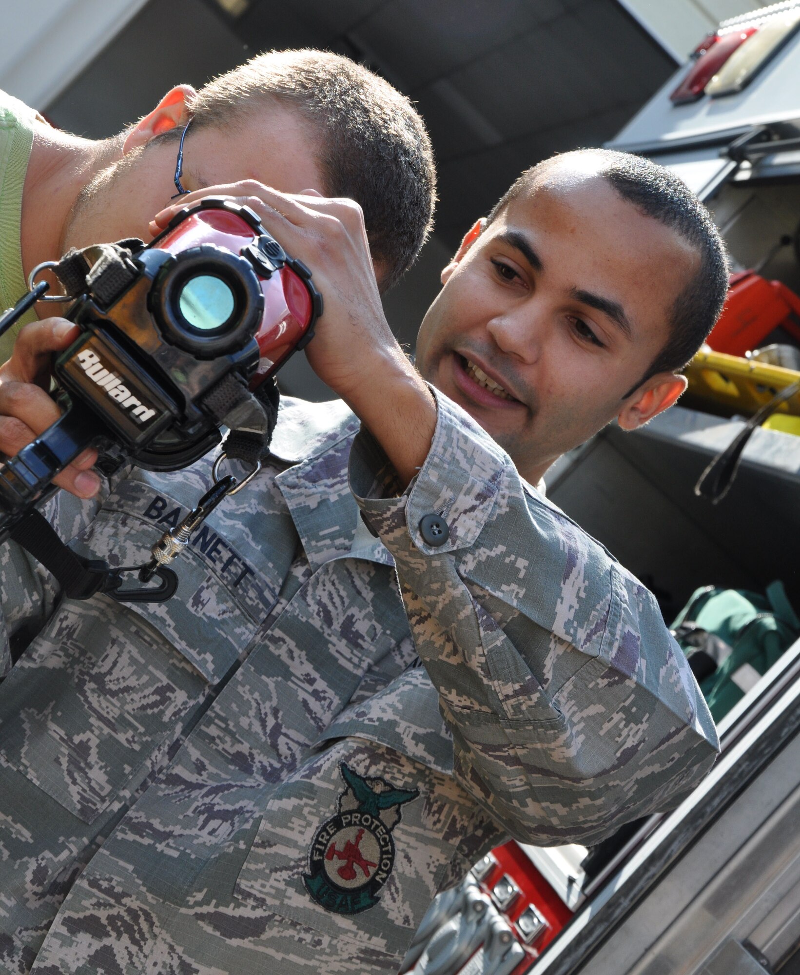 Staff Sgt. Carl Barnett, 325th Civil Engineer Squadron fire fighter, demonstrates a thermal imaging camera to a Twin Oaks Juvenile Education Program member as part of a base tour Nov. 20. Members of the program receive mentoring from the 325th Security Force Squadron. The Twin Oaks program provides troubled youth the chance to change their lives from the path of a habitual offender to that of a successful, productive, law-abiding citizen. (U.S. Air Force Photo by Ashley M. Wright) 
