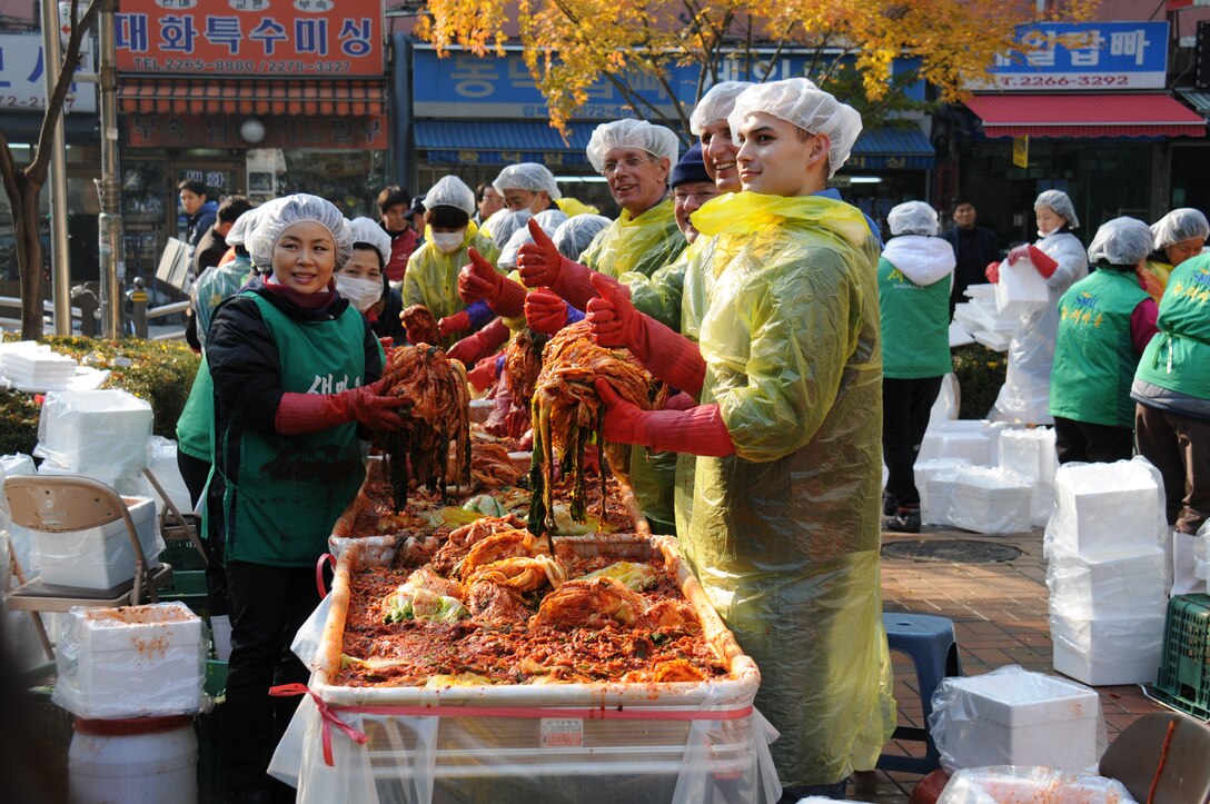 Joe Campbell (far left), from Public Affairs Office, Basil Meyer (second from left), from Contracting Division, Sam Adkins (third from left) Chief of Construction Division, Christopher Shane (right) from Logistic Management Office enjoys making kimchi for elderly and needy.  Members of FED volunteered to make kimchi in order to promote friendship between the Republic of Korea and the U.S. Nov. 22.