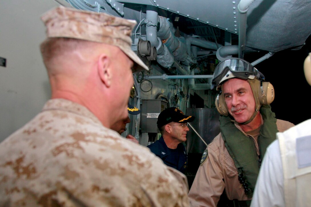 Colonel Scott D. Campbell, commanding officer, 15th Marine Expeditionary Unit, greets Rear Adm. William K. Lescher, commander, Expeditionary Strike Group 5, after he arrived aboard USS Peleliu, Nov. 24. The 15th MEU is deployed as part of the Peleliu Amphibious Ready Group as a U.S. Central Command theater reserve force, providing support for maritime security operations and theater security cooperation efforts in the U.S. 5th Fleet area of responsibility. (U.S. Marine Corps photo by Cpl. John Robbart III/ Released)