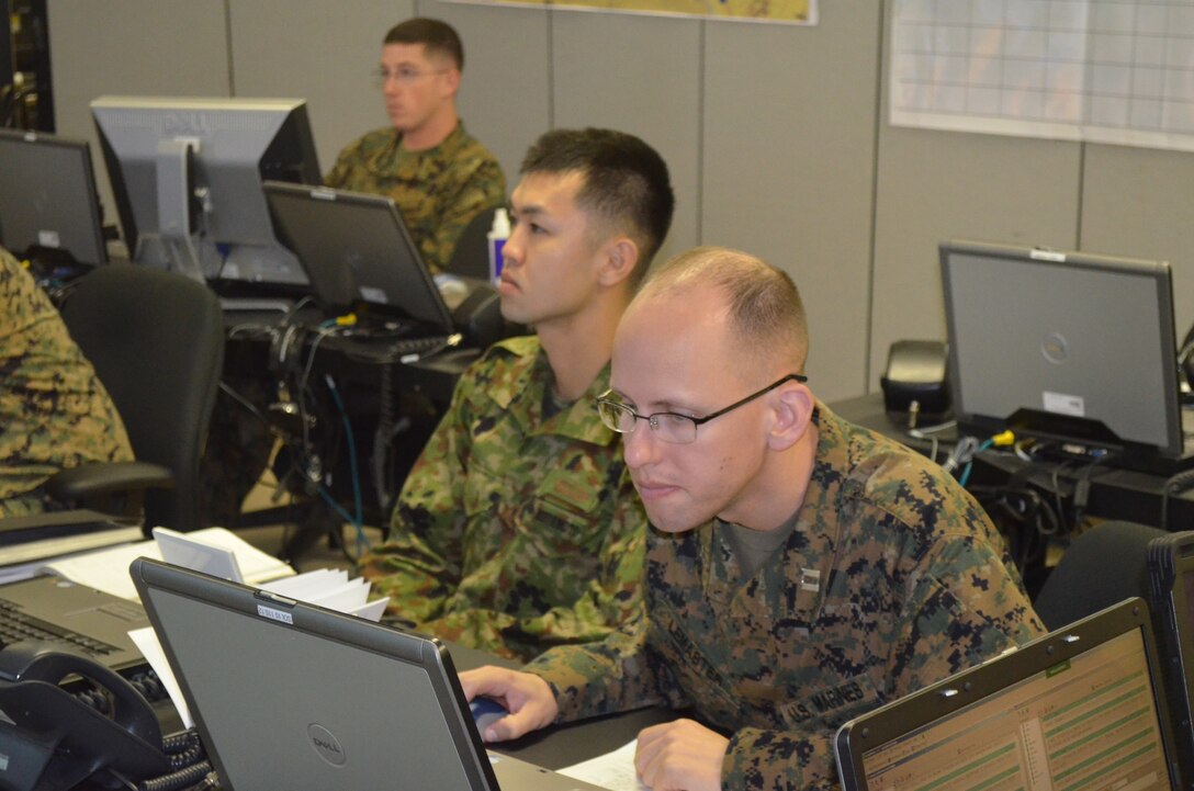 121121-M-TR505-370

CAMP HANSEN, Okinawa, Japan – 1st Lt. Miyamoto Naoya and Capt. Ralph LeMaster take part in a Watch Officer, Watch Chief and Battle Staff Training Course here Nov. 14-21.  The course is provided by the Marine Air-Ground Task Force Integrated Systems Training Center and designed to improve unit readiness and ability to respond to contingencies in the Asia-Pacific.  This will allow Marines with the 3rd MEB and members of the Japan Ground Self-Defense Force to more effectively command and control forces assigned to them in the event of a crisis or contingency. Naoya is a platoon commander with the 11th Infantry Regiment and LeMaster is the Assistant Operations Officer for the 3rd MEB.
