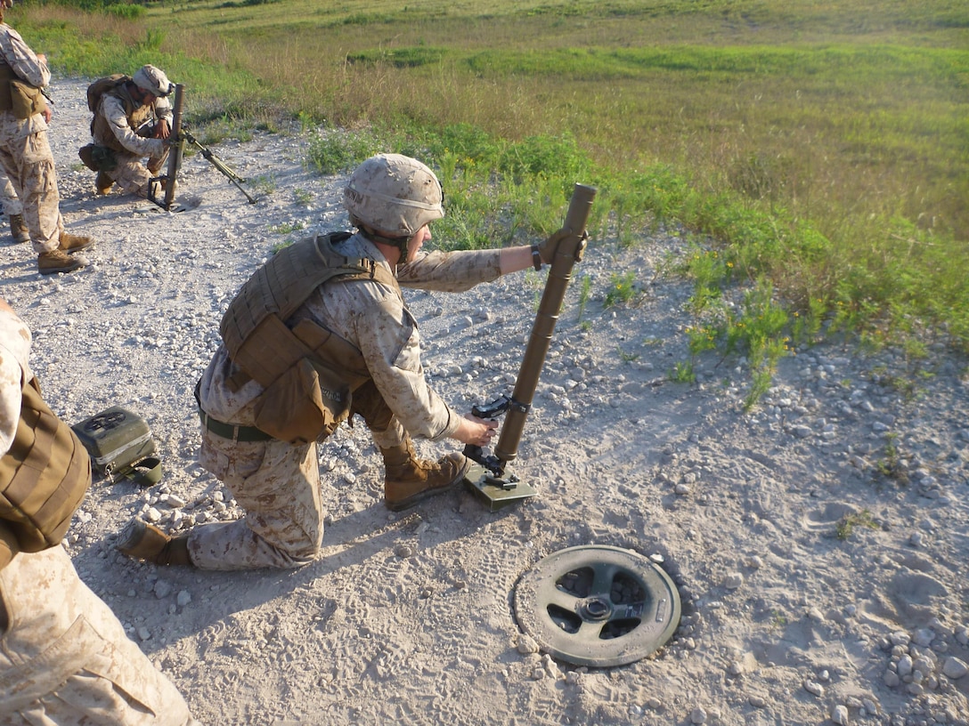 Cpl St. Julien W. Cannon fires a 60mm mortar round from the hand held during a Weapons Platoon range at G-3.