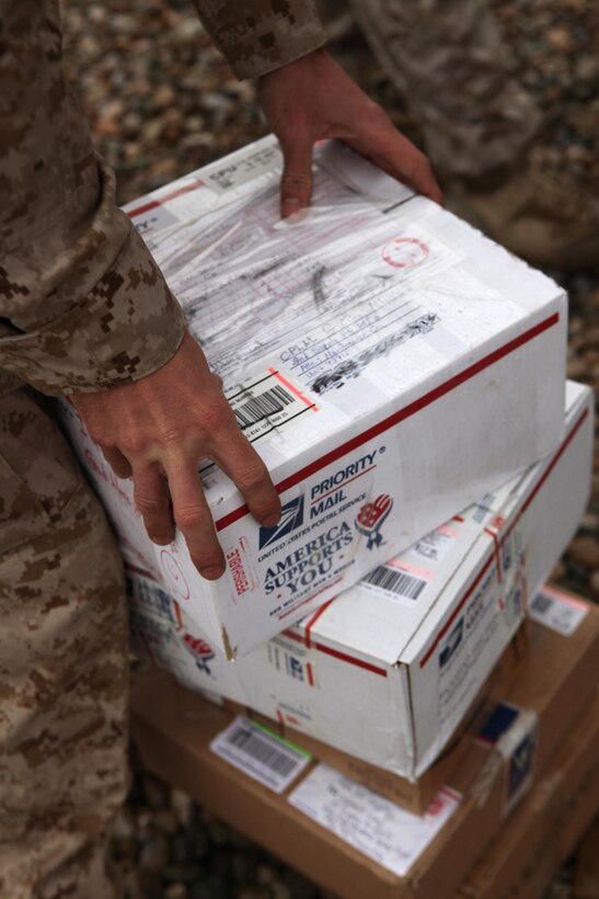 A Marine with Marine Air-Ground Task Force Support Battalion 11.2, 2nd Marine Logistics Group (Forward), stacks packages for his unit during daily mail call aboard Camp Leatherneck, Afghanistan, Oct. 10, 2011.  Mail is collected and delivered aboard the base seven days a week.