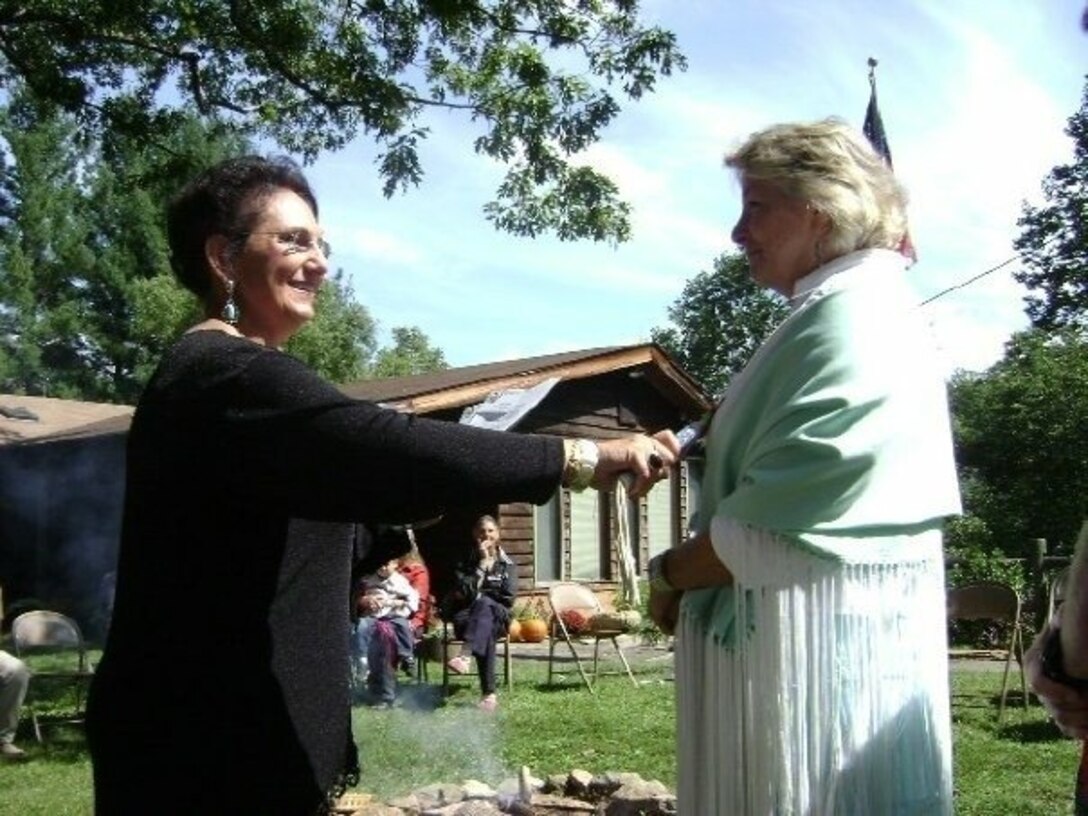 Phyllis Hurlock (right) of Marine Corps Systems Command’s (MCSC) Programs office receives her Native American name "Wabnokwe" during a Potawatomi ceremony from Linda Capps, the tribe's Vice Chairman.
