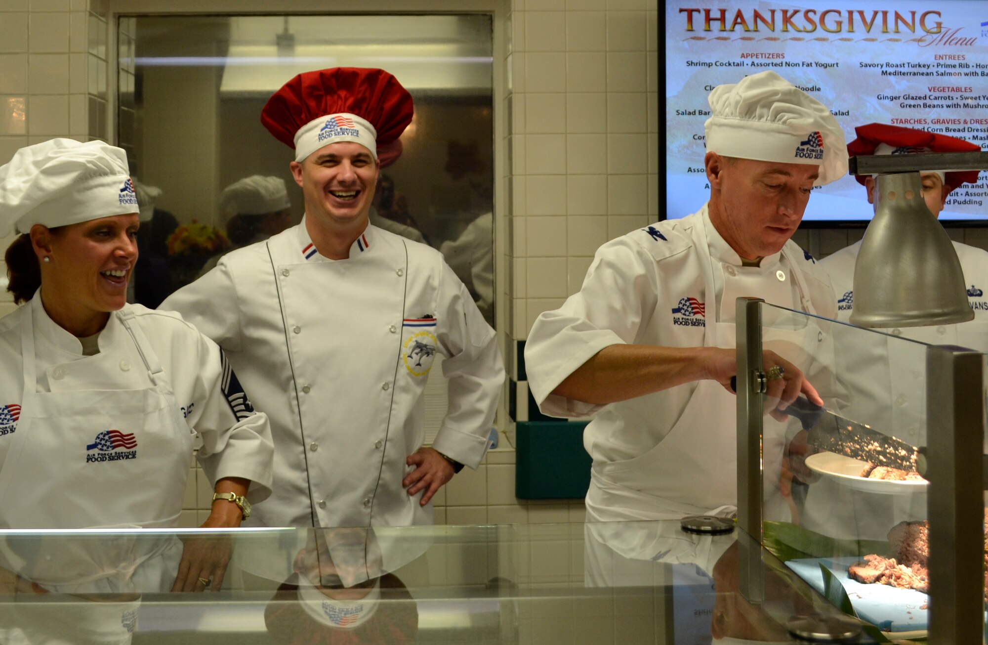 Col. Dann Carlson, Joint Base Pearl Harbor-Hickam vice commander and 647th Air Base Group commander, serves food for Airmen during a Thanksgiving meal at a dining facility on Joint Base Pearl Harbor-Hickam, Hawaii, Nov. 22.