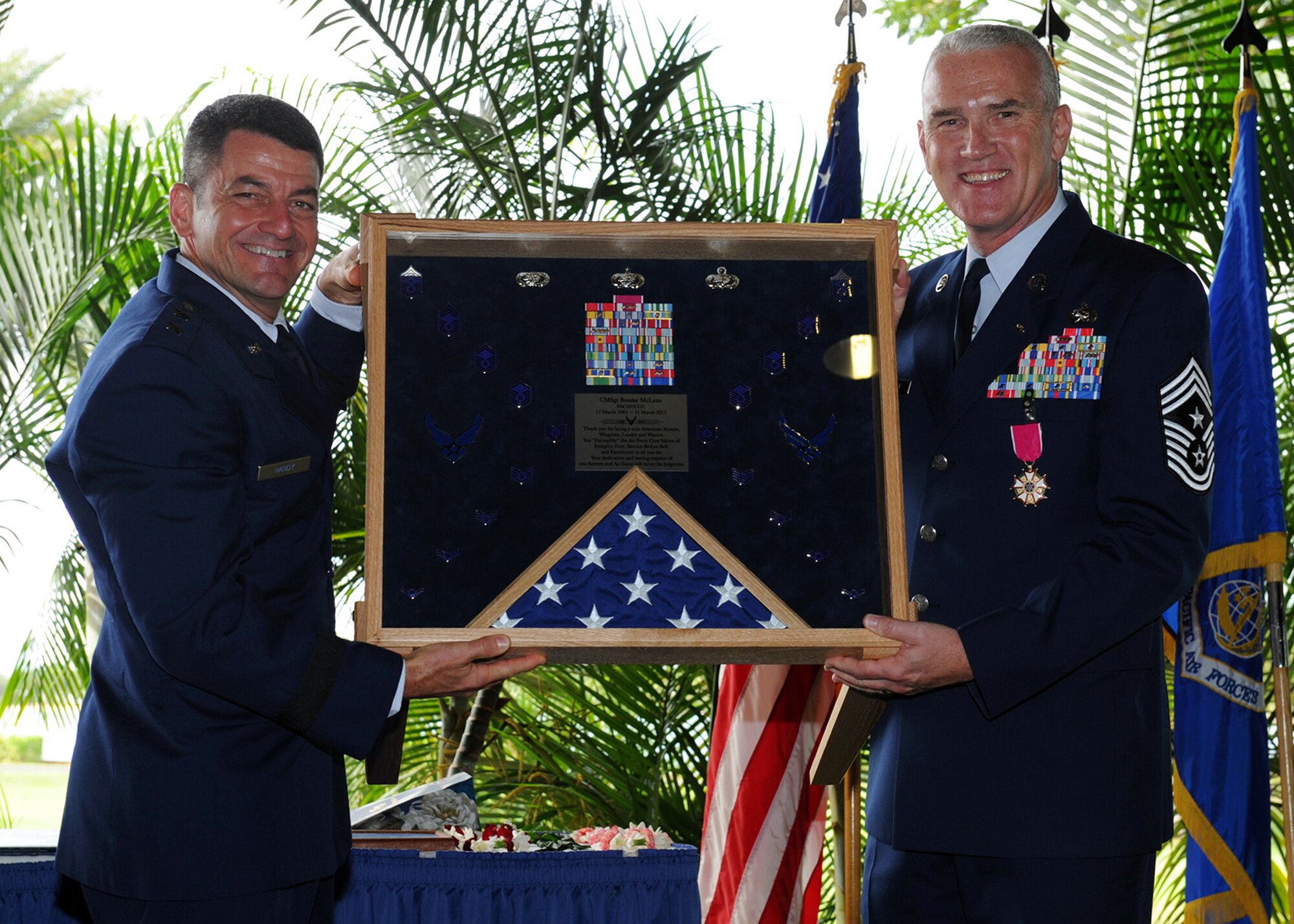 Maj. Gen. Russell J. Handy, Pacific Air Forces Director of Operations, Plans, Requirements and Programs, presents Chief Master Sgt. Brooke McLean, PACAF command chief with a shadow box during McLean’s retirement ceremony at the Officer’s Club Lanai, Joint Base Pearl Harbor-Hickam, Hawaii, Nov. 16, 2012. The military shadow box is one of the most highly valued components of a service member’s retirement ceremony, which are designed to commemorate a long career of dedicated service. (U.S. Air Force photo/Jerome S. Tayborn/Released)
