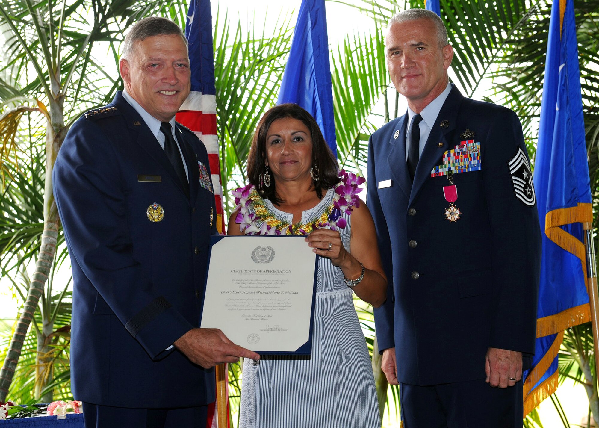 Retired Gen. Gary North, former Pacific Air Forces commander, Mrs. Shelley McLean and her spouse Chief Master Sgt. Brooke McLean, PACAF command chief, pose for a photo at McLean’s retirement ceremony at the Officer’s Club Lanai, Joint Base Pearl Harbor-Hickam, Hawaii, on Nov. 16, 2012. Gen. North presented Mrs. McLean with a retirement certificate during her spouse’s ceremony, for her unwavering support and personal sacrifice. (U.S. Air Force photo/Tech. Sgt. Jerome S. Tayborn/RELEASED)