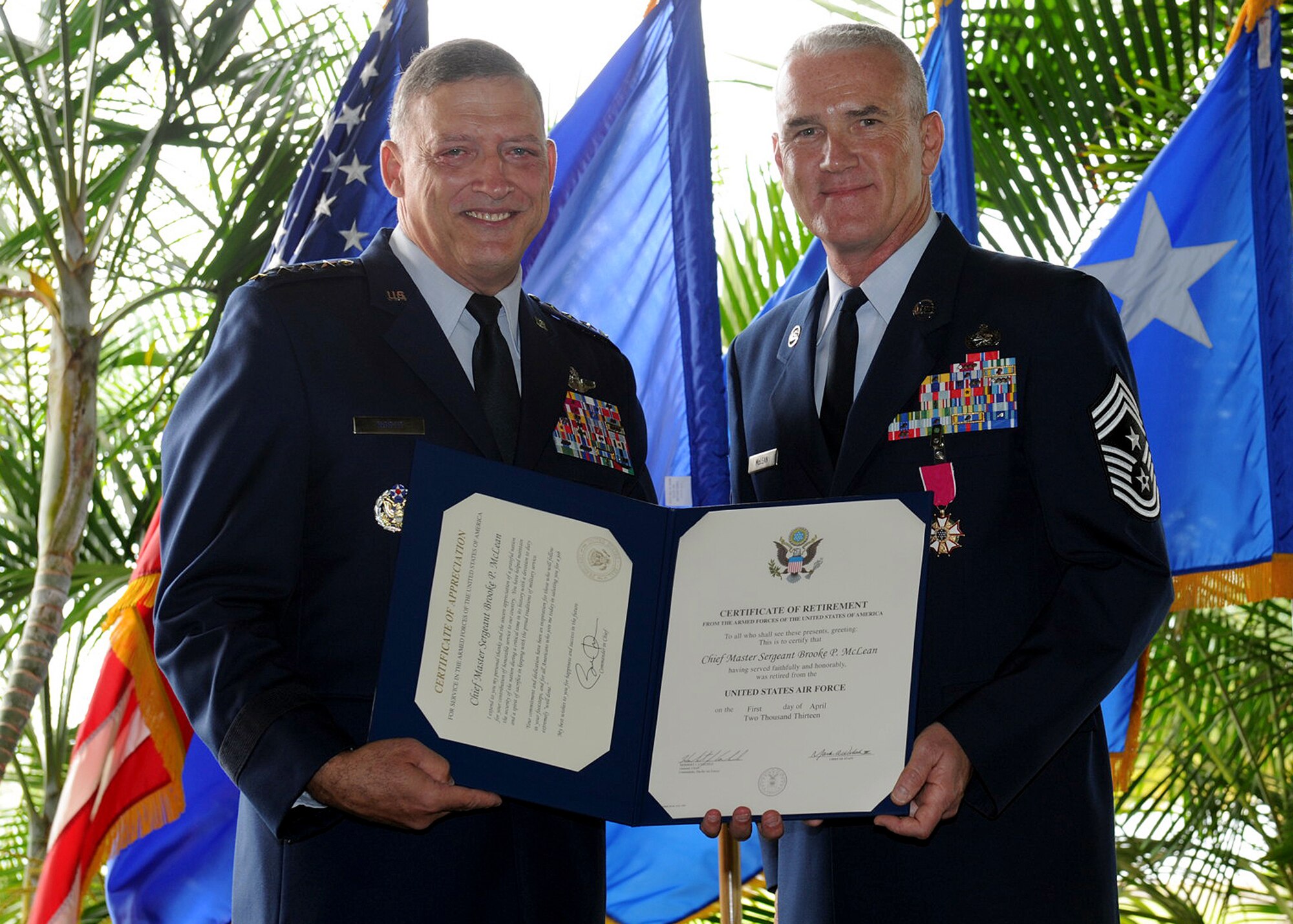 Retired Gen. Gary North, former Pacific Air Forces commander, presents Chief Master Sgt. Brooke McLean, PACAF command chief, with his retirement certificate during his retirement ceremony at the Officer’s Club Lanai, Joint Base Pearl Harbor-Hickam, Hawaii, on Nov. 16, 2012. McLean retires after 30 years of service. (U.S. Air Force photo/Tech. Sgt. Jerome S. Tayborn/Released)