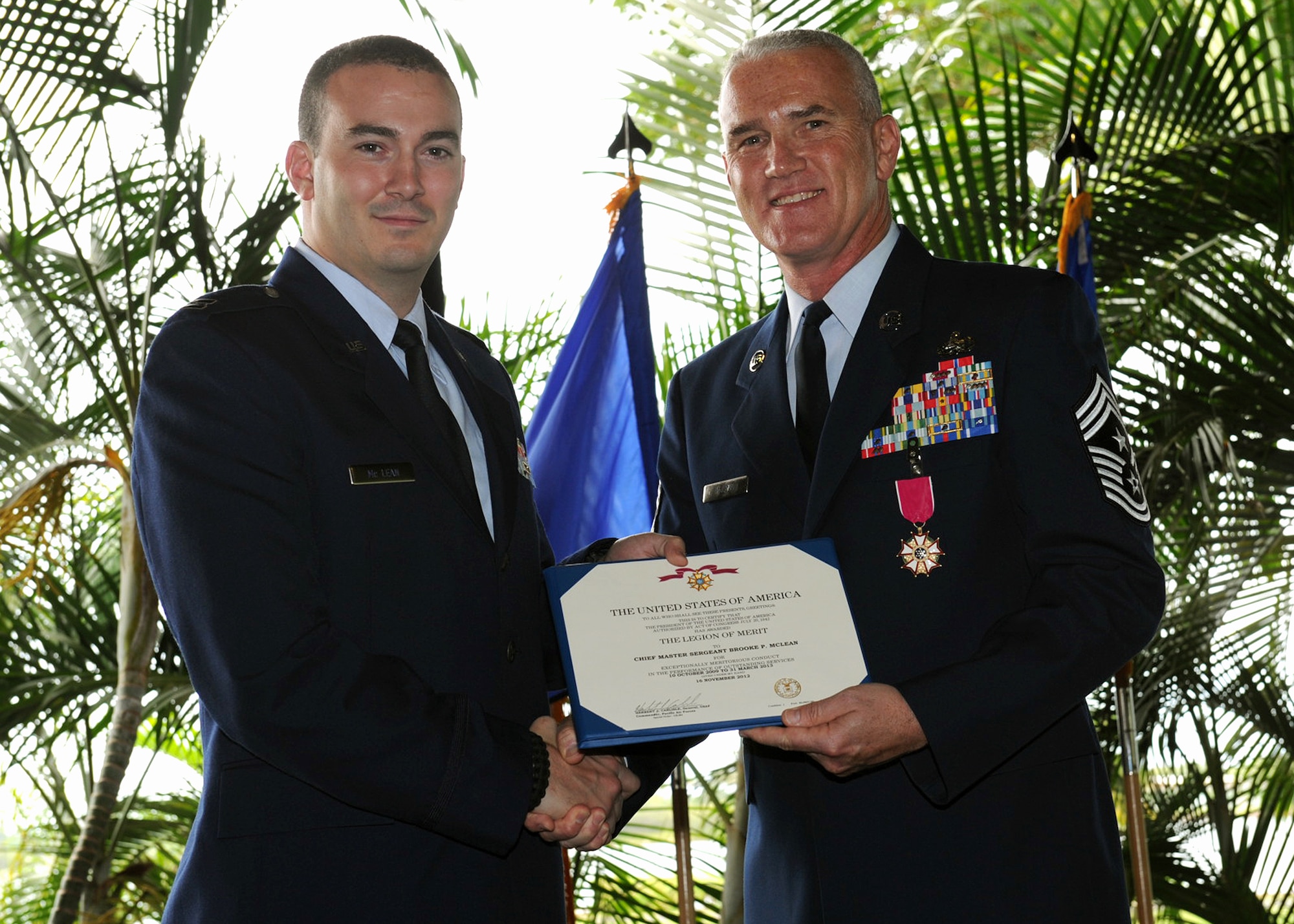 Capt. Vince K. McLean, 621st Contingency Response Wing, Africa Air Advisor, presents his father Chief Master Sgt. Brooke McLean, PACAF command chief, the Legion of Merit certificate during his retirement ceremony at the Officer’s Club Lanai, Joint Base Pearl Harbor-Hickam, Hawaii, on Nov. 16, 2012. The Legion of Merit is a military award of the Armed Forces that is given for exceptionally meritorious conduct in the performance of outstanding services. (U.S. Air Force photo/Tech. Sgt. Jerome S. Tayborn/Released)
