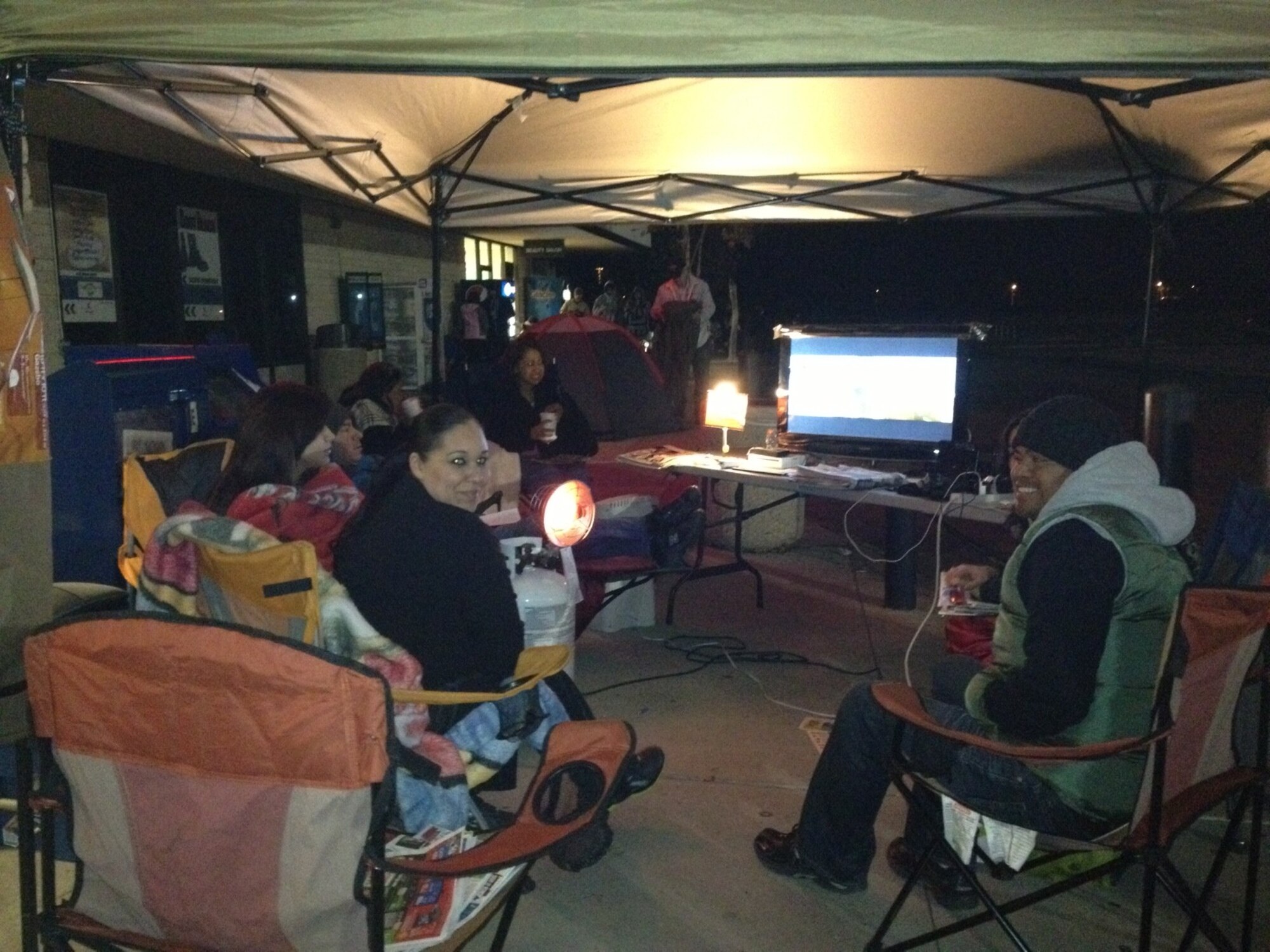 This family began camping out at 6 a.m. on Thanksgiving morning for the sales at the exchange. (Photo coutesy to U.S. Air Force)