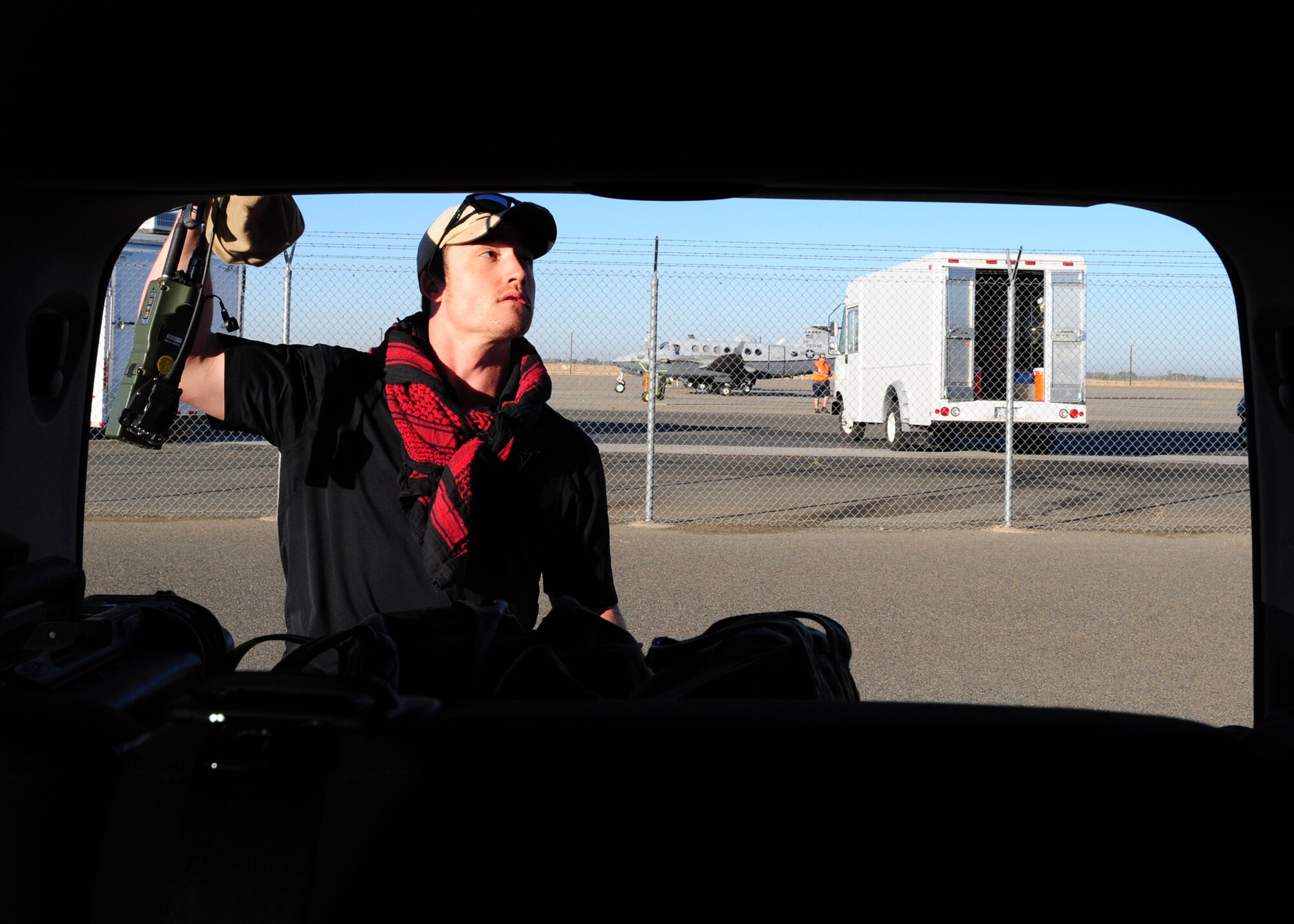 Wes Shover, a joint terminal attack controller expert from the base contractor Rally Point Management, prepares to act as an opposition force as an MC-12W Liberty intelligence, surveillance, and reconnaissance aircraft prepares to take off in the background at Beale Air Force Base, Calif., Oct. 17, 2012. OPFORs are all current or prior Special Forces members who pretend to be the best bad guys they can be. They travel Beale’s 24,000 acres planting simulated IEDs, carrying inert rockets, and hide in vehicles or at shops around base, essentially playing an adult game of hide and seek. (U.S. Air Force photo by Senior Airman Shawn Nickel/Released)