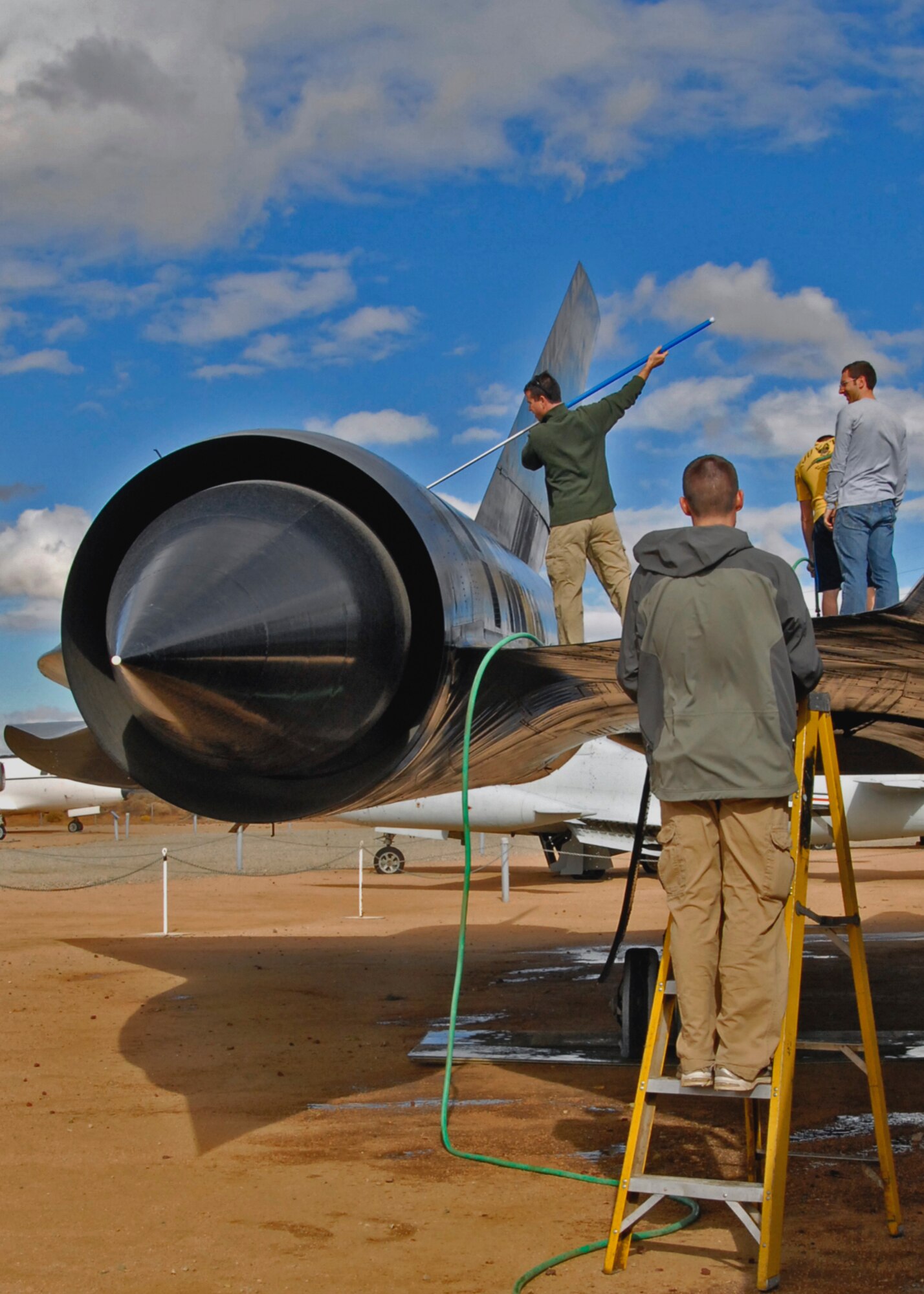 Students from United States Air Force Test Pilot School Class 12B cleans the SR-71 Blackbird Nov. 17 at the Air Force Flight Test Museum. The class adopted the aircraft as a way to give back to the museum. (Air Force Photo by Laura Mowry)