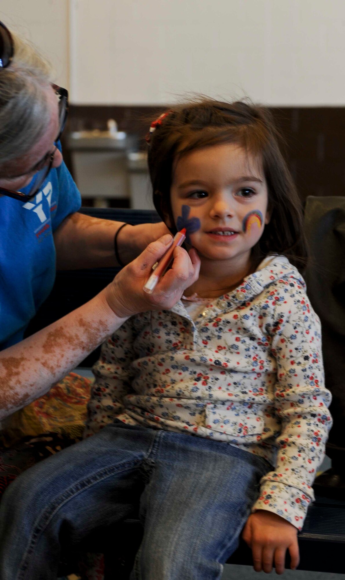 Ashlynn Mehl, daughter of Master Sgt. Michael Mehl, 37th Bomb Squadron, has her face painted during the week of the Air Force Family kickoff event inside the Pride Hangar at Ellsworth Air Force Base, S.D., Nov. 17, 2012. The event expressed the Air Force’s gratitude to military families who make great sacrifices to serve our country on a continuous basis. (U.S. Air Force photo by Airman 1st Class Anania Tekurio/Released)