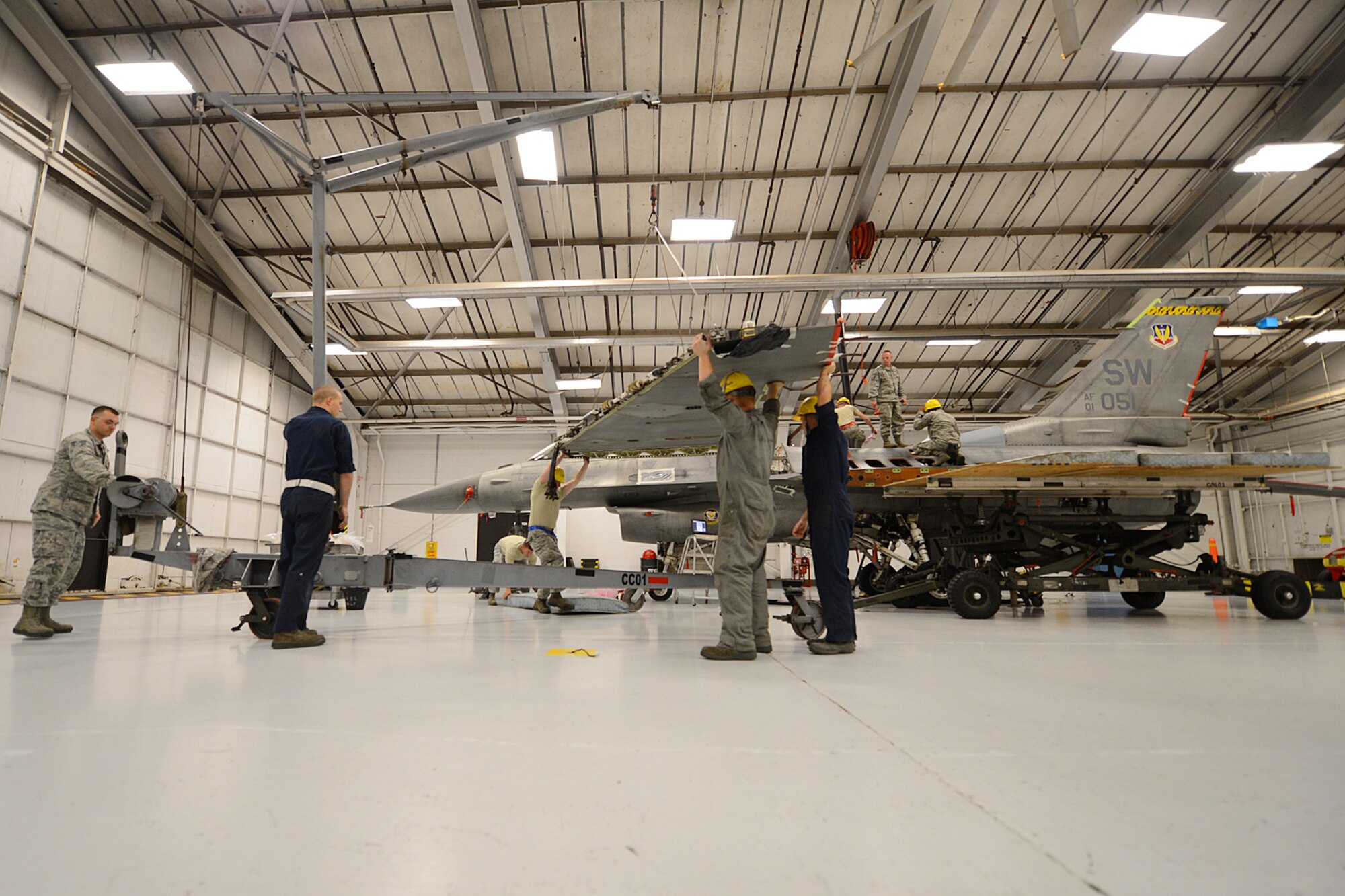 U.S. Air Force Airmen assigned the 20th Maintenance Group remove a wing from an F-16 Fighting Falcon at Shaw Air Force Base, S.C., Nov. 19, 2012. The wing was replaced due to an internal leak, which needed further maintenance.(U.S. Air Force photo by Airman Nicole Sikorski/Released)