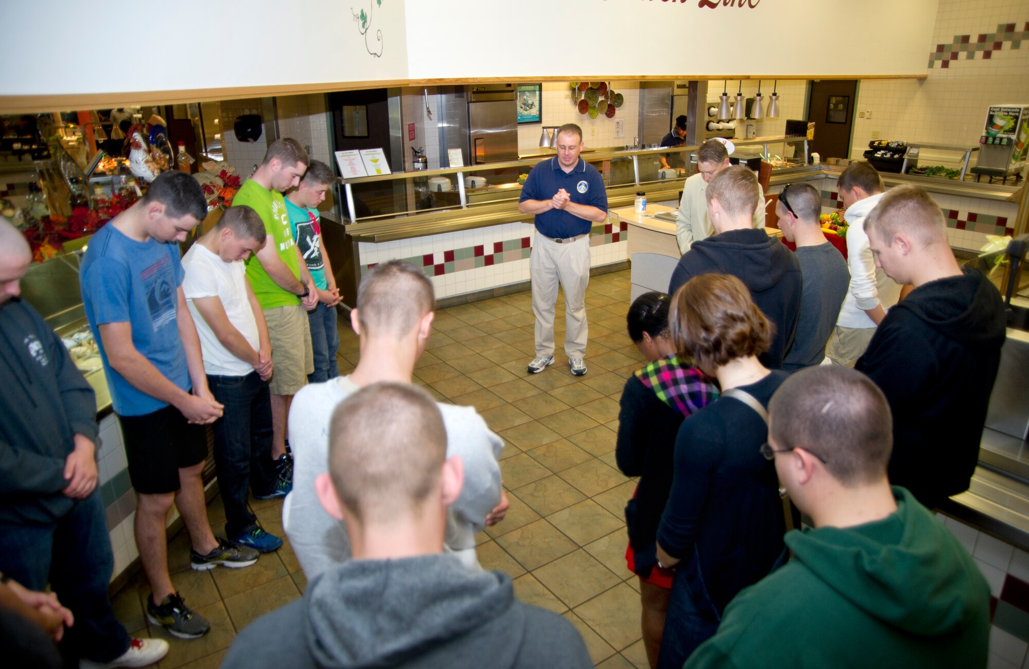 Chaplain (Capt.) John Schuetze, 81st Training Wing, leads a blessing for the Thanksgiving meal at the Azelea Dining Facility Nov. 22, 2012, at Keesler Air Force Base, Miss.  It is traditional at Keesler for commanders, first sergeants and superintendents to take time out of their holiday to serve a Thanksgiving meal at the dining facilities to their Airmen. (U.S. Air Force photo by Adam Bond)
