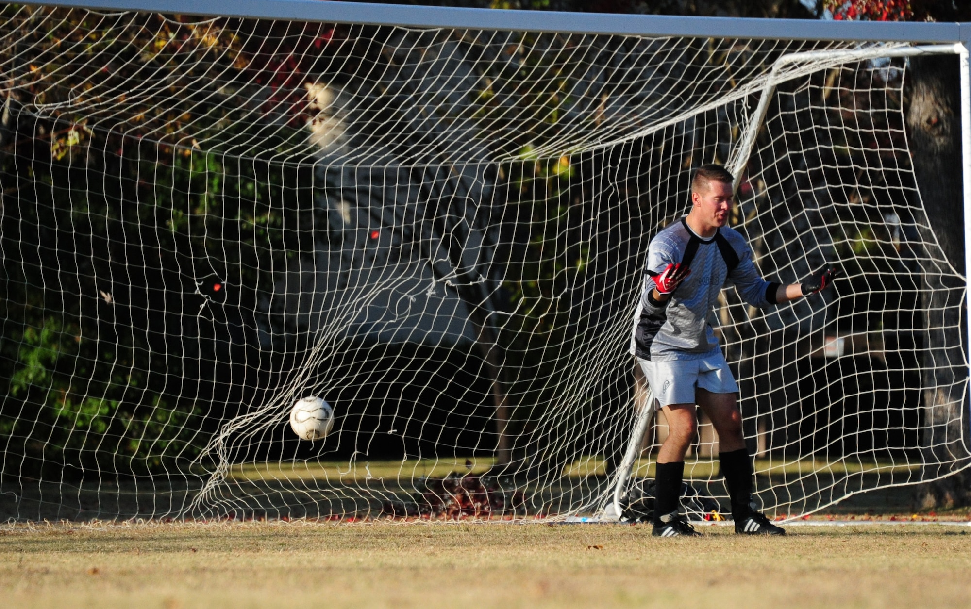 Kevin Bush, Squadron Officer School instructor, misses the ball as it soars into the net during a friendly match of soccer against International Officer School students on Nov. 16. In the end, IOS proved too much for SOS as they won with a score of 6-2. (U.S. Air Force photo by Senior Airman Christopher Stoltz)