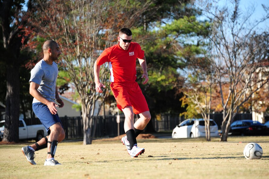 International Officer School student Mohammed Muaydh pursues Squadron Officer School instructor Erick Clayson as he attempts to drive the ball downfield during a friendly soccer match between the Squadron Officer School and International Officer School students on Nov. 16. In the end, IOS proved too much for SOS as they won with a score of 6-2. (U.S. Air Force photo by Senior Airman Christopher Stoltz)