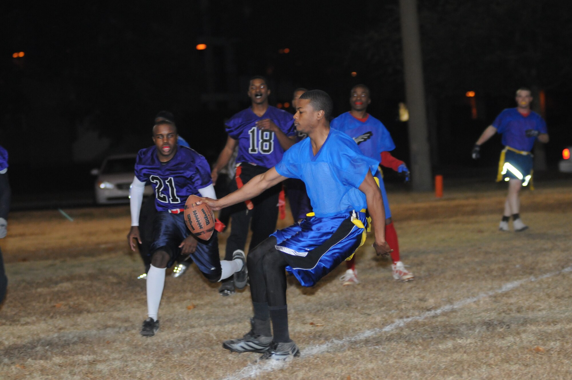 Derek Lewis, 334th Training Squadron quarterback, decided to take the football himself for a touchdown as Terrill James and Rashad Campbell, 403rd Wing, close in on defense during the intramural flag football championship game Nov. 26, 2012, Keesler Air Force Base, Miss.  The 334th TRS defeated the 403rd, 28-26.  (U.S. Air Force photo by Kemberly Groue)