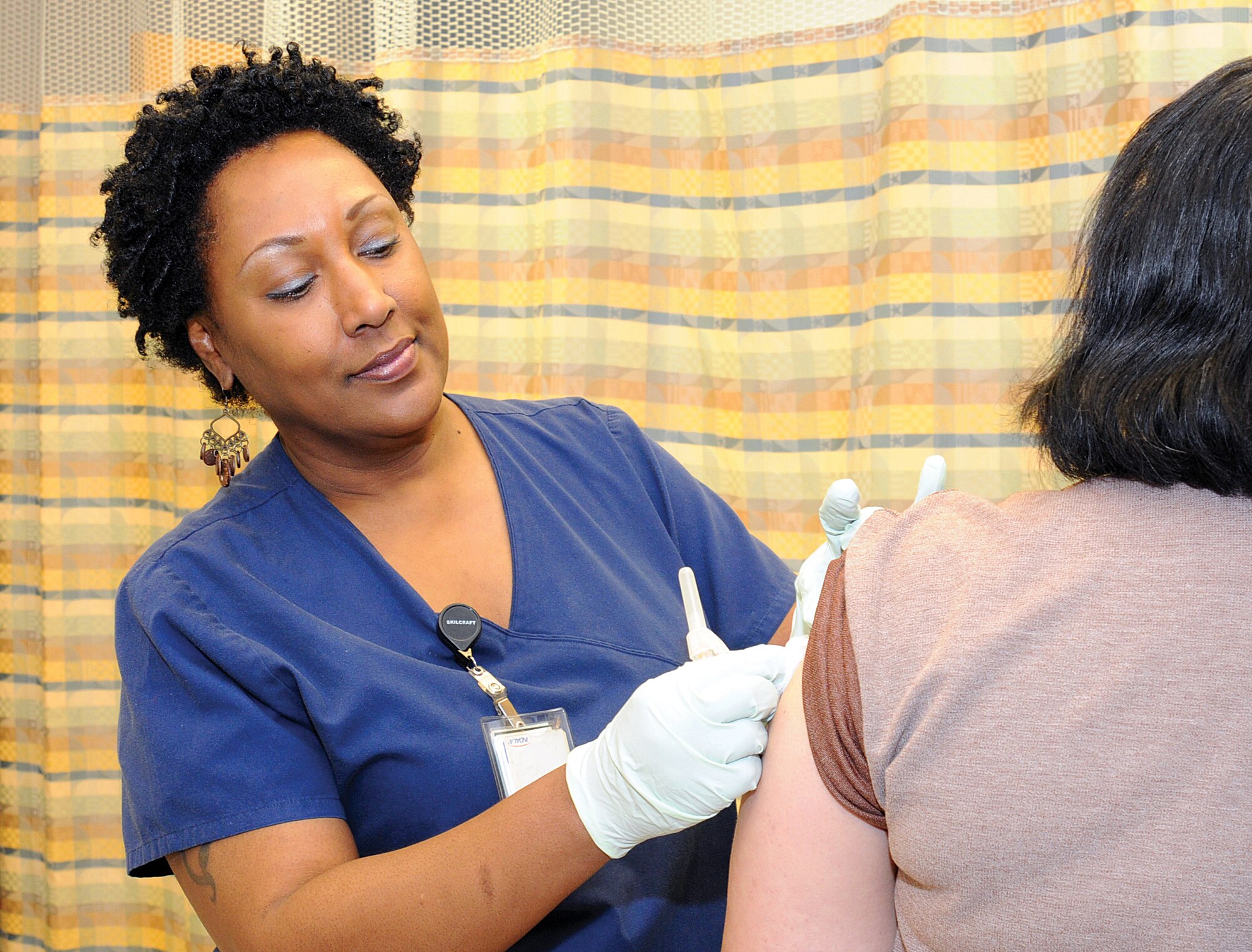 Daisy Bolden, R.N., is ready to give flu shots to Tinker civilian workers who come to the Occupational Medicine Clinic in Bldg. 3334 for the free vaccine. When not administering the shots in the facility Tuesdays and Thursdays from 10 to 11 a.m. and 2 to 3 p.m., medical staff travel to various scheduled locations on base to give the shots. (Air Force photo by Margo Wright)