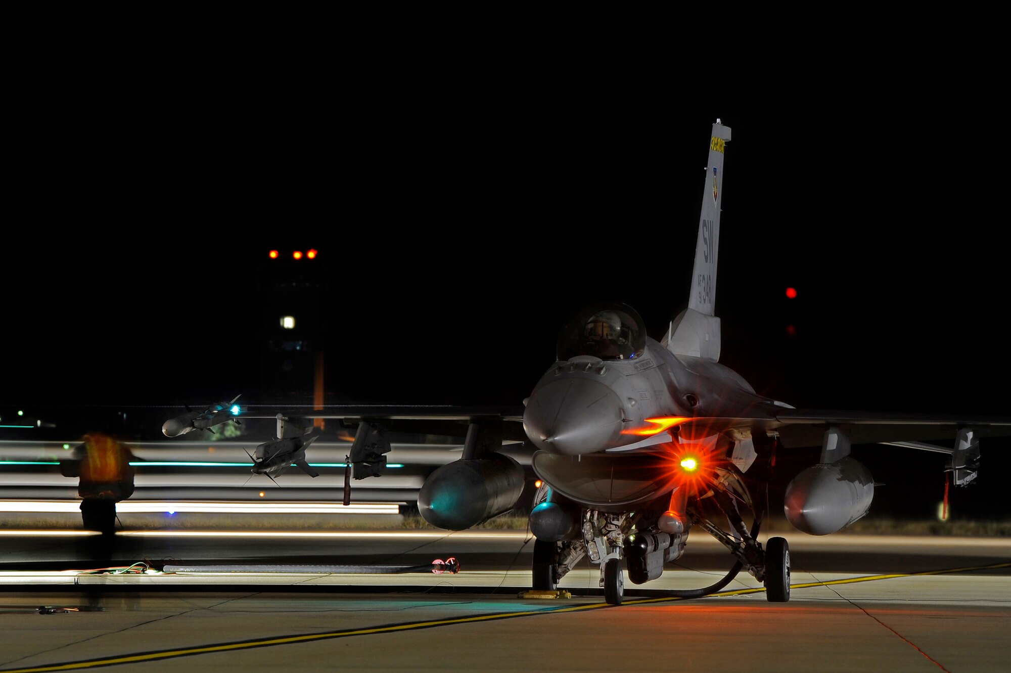 U.S. Air Force F-16 Fighting Falcons move rapidly as fuels operators and crew chiefs execute a technique called hot pit refueling, Nov. 9, 2012, Shaw Air Force Base, S.C. Hot pit refueling is a procedure usually performed in a combat situation to rapidly refuel aircraft while their engines are running, resulting in a speedy refuel to thrust pilots right back into the fight. Airmen assigned to the 20th Logistics Readiness Squadron and 20th Aircraft Maintenance Squadron practice this technique to keep their skills sharp and aid in the effort to provide combat-ready air power at a moment’s notice. (U.S. Air Force photo by Staff Sgt. Kenny Holston/Released)