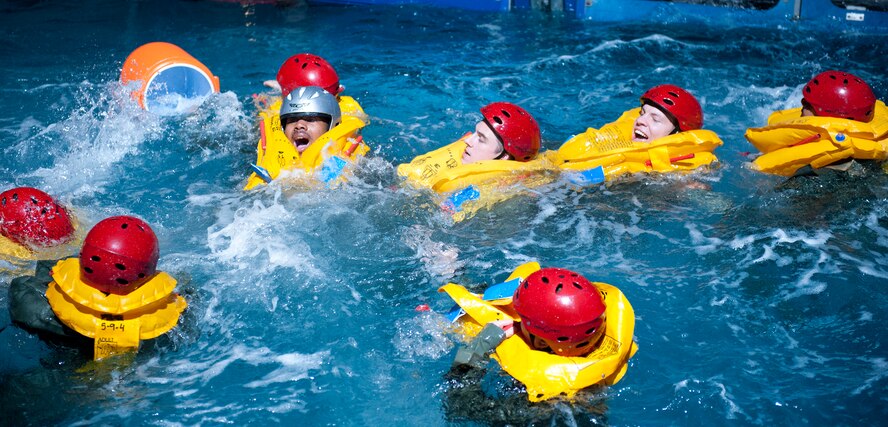Students egress out of the Modular Egress Training System to a raft during SV90 at Fairchild Air Force Base, Wash., Oct. 19. SV90 is a two day course to prepare aircrew for egress in the open ocean. The course trains aircrew to ditch the aircraft, get into a life raft and surviving until they are recovered in a simulated open ocean environment. (U.S. Air Force photo by Staff Sgt. Michael Means)