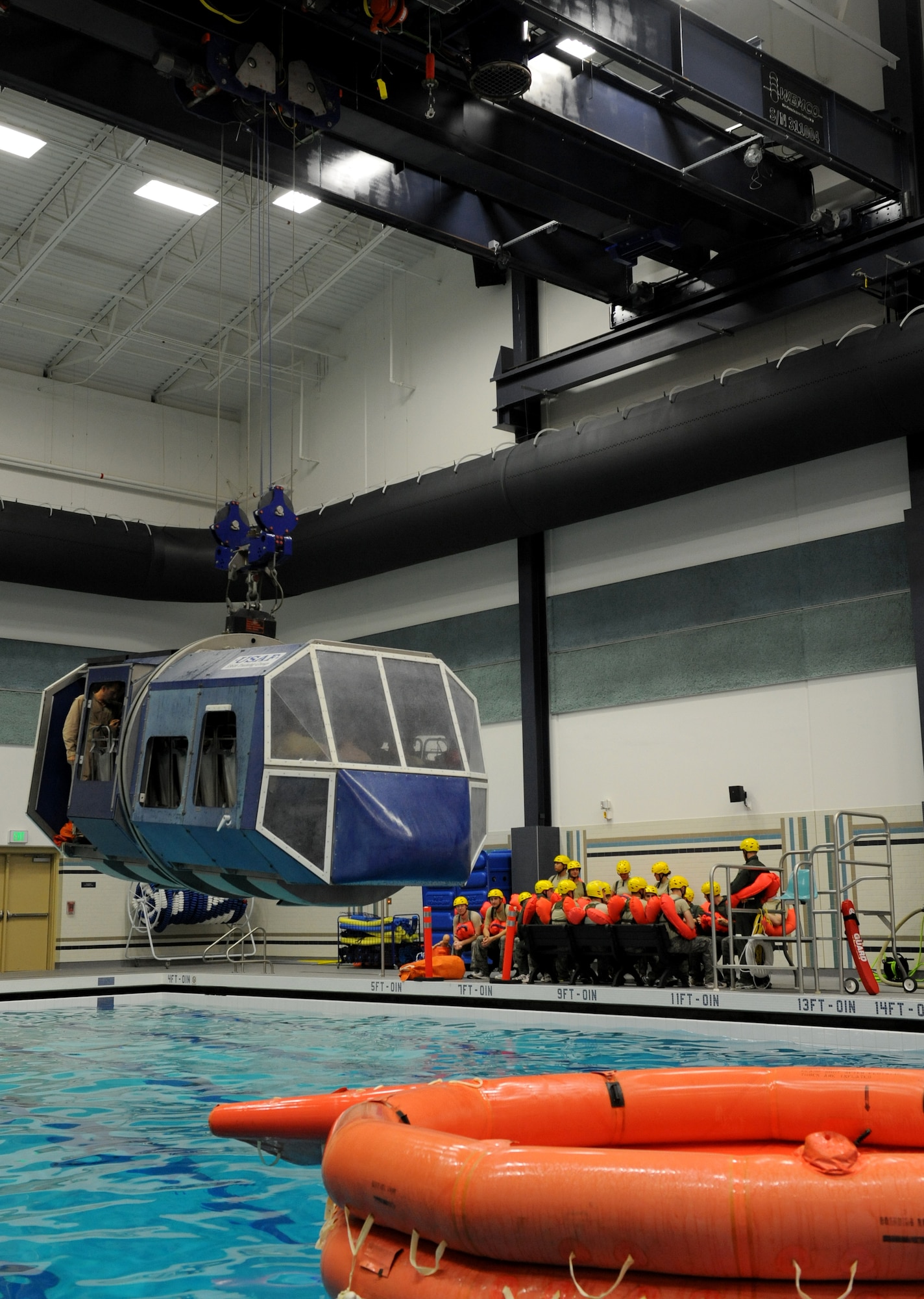 Students are place in the Modular Egress Training System during SV90 at Fairchild Air Force Base, Wash., Oct. 19. SV90 is a two day course to prepare aircrew for egress in the open ocean. The METS is operated remotely and lifted by a crane system capable of lifting up to 24,000 lbs. (U.S. Air Force photo by Staff Sgt. Michael Means)