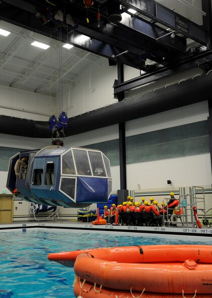 Students are place in the Modular Egress Training System during SV90 at Fairchild Air Force Base, Wash., Oct. 19. SV90 is a two day course to prepare aircrew for egress in the open ocean. The METS is operated remotely and lifted by a crane system capable of lifting up to 24,000 lbs. (U.S. Air Force photo by Staff Sgt. Michael Means)