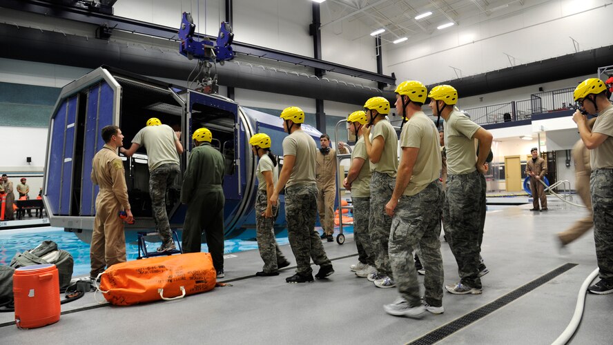 Survival, Evasion, Resistance and Escape students climb in the Modular Euiess Training System in the aquatics center at Fairchild Air Force Base, Wash., Oct. 12, 2012. The water survival course is just one part S.E.R.E. students must complete in order to graduate. (U.S. Air Force photo by Airman 1st Class Ryan Zeski)
