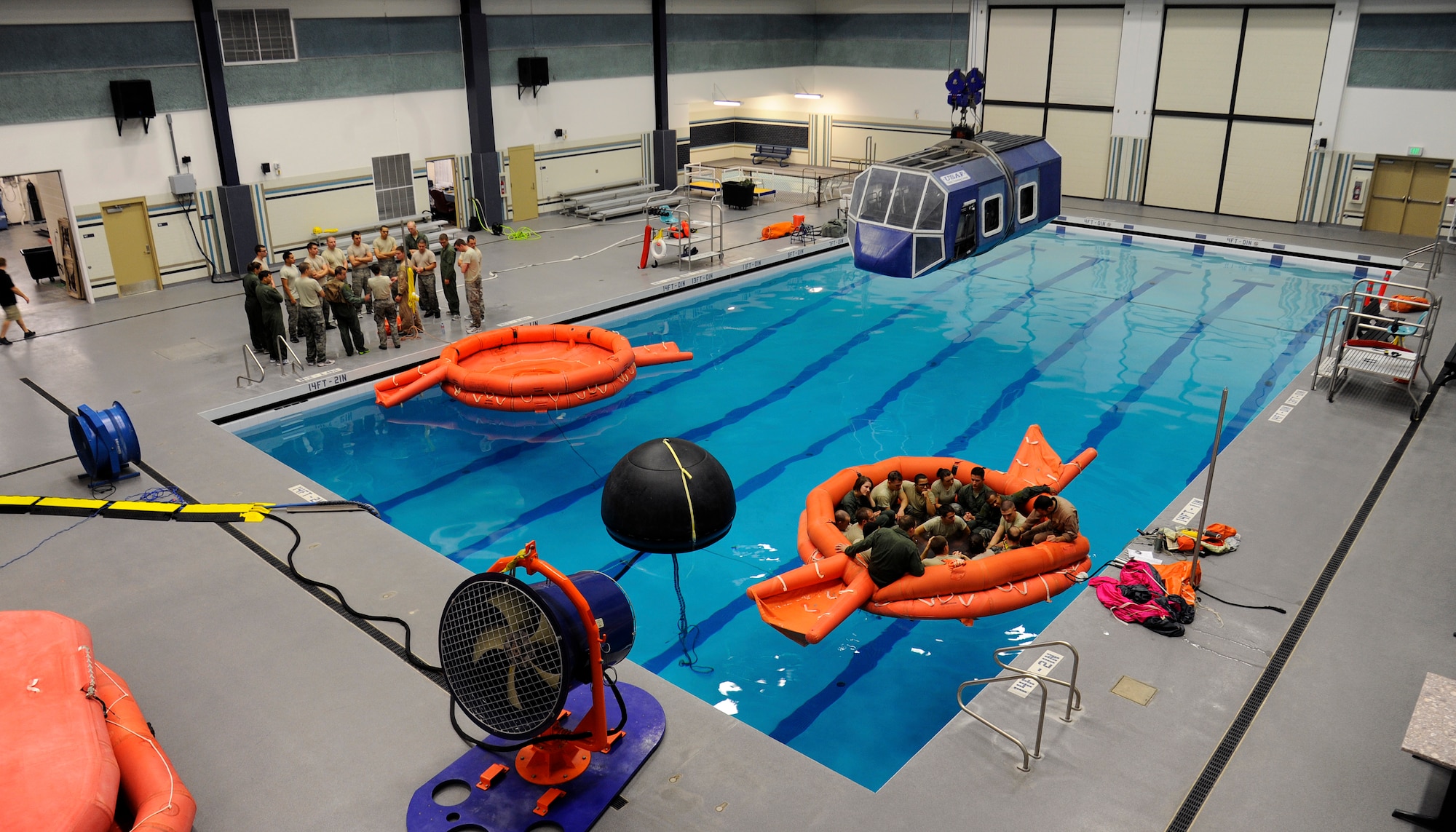 Survival, Evasion, Resistance, Escape and instructors brief their students before they begin water training in the aquatics center at Fairchild Air Force Base, Wash., Oct. 12, 2012. The water survival course is just one part S.E.R.E. students must complete in order to graduate. (U.S. Air Force photo by Airman 1st Class Ryan Zeski)