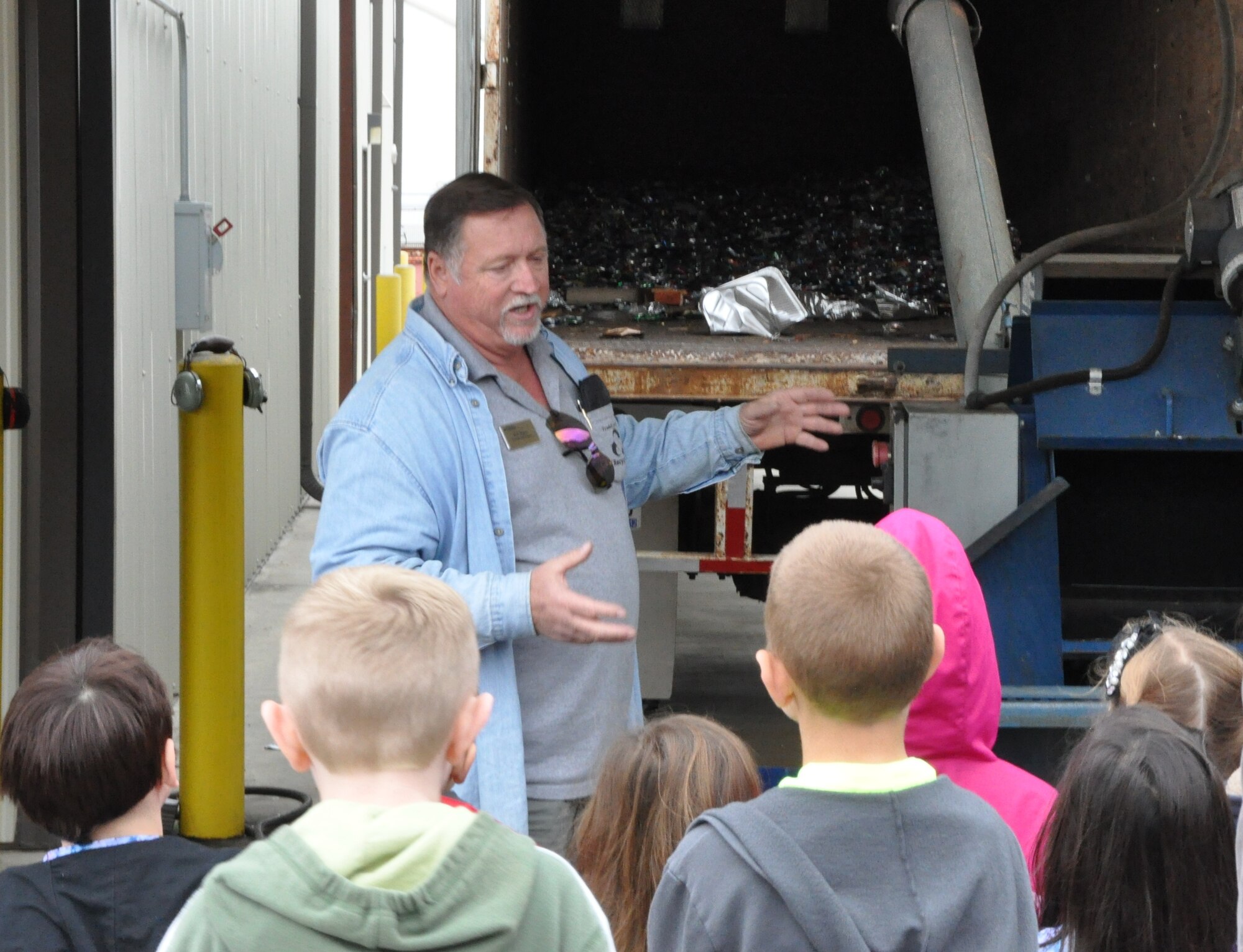 Robert Myers, Tyndall Recycling Center coordinator, talked to students from Lynn Haven Elementary about the processes for recycling aluminum cans, during the student's tour of the facility Nov. 15. (U.S. Air Force photo by Senior Airman Christopher Reel)