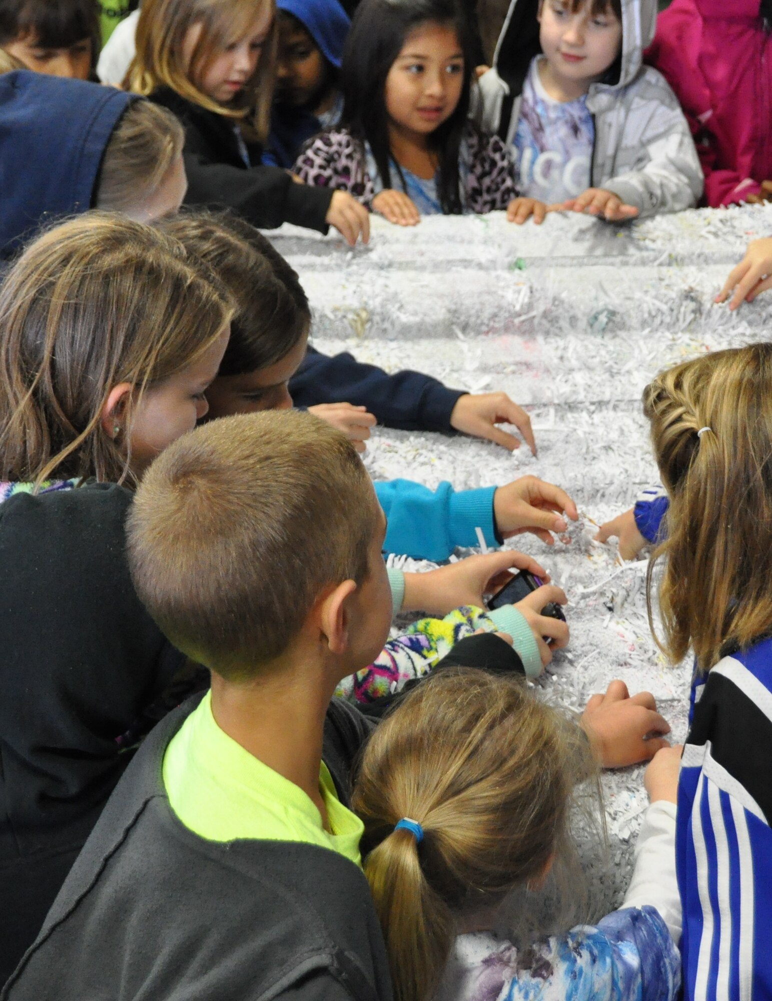 Students from Lynn Haven Elementary earned a tour to the Tyndall Recycling Center and 325th Civil Engineer Squadron natural resources for National Recycling Day, Nov. 15. The children pick at and feel a bail of recycled paper. (U.S. Air Force photo by Senior Airman Christopher Reel)