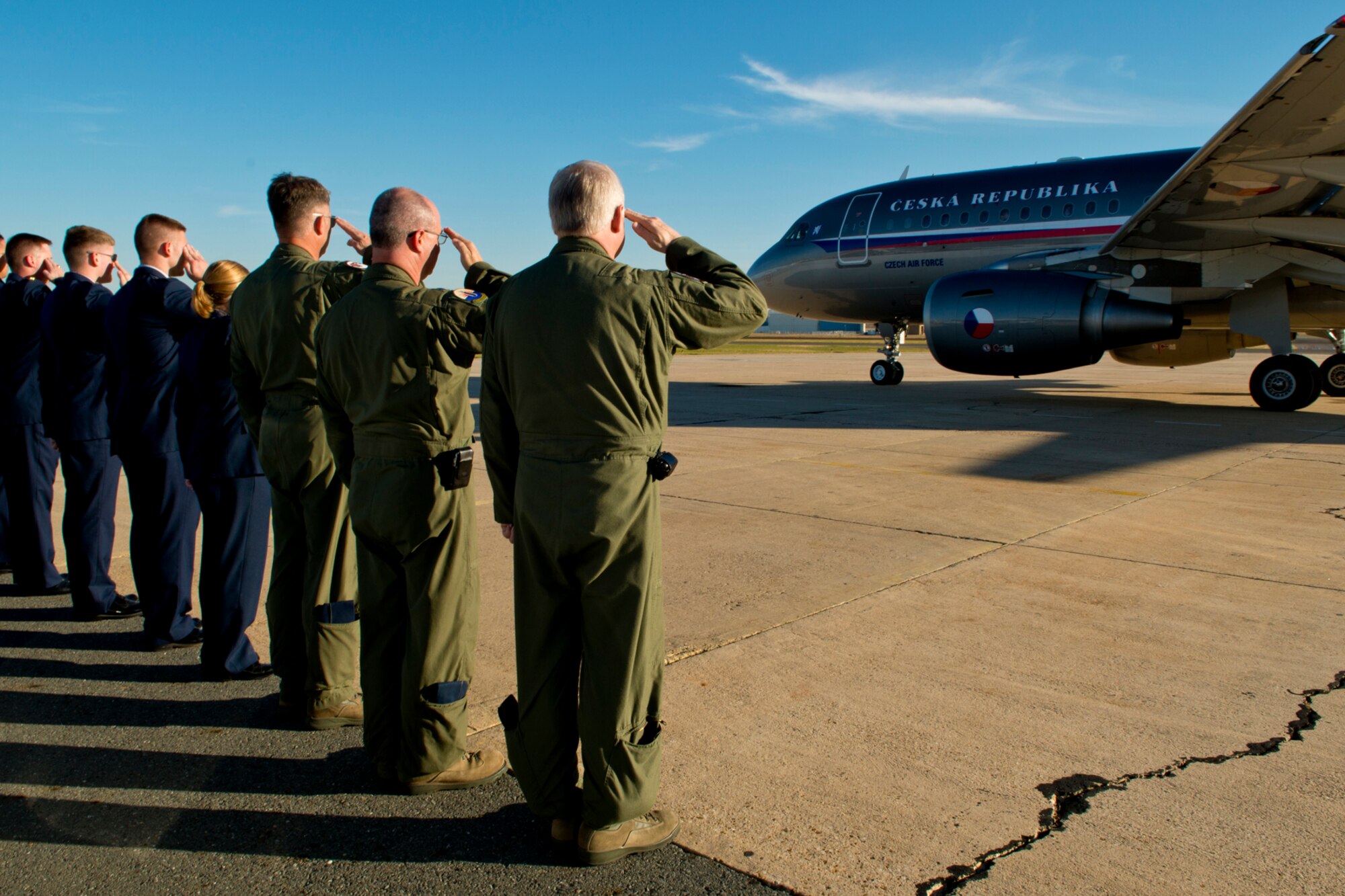 Members of the 307th Bomb Wing hold a salute as the aircraft carrying the Minister of Defense of the Czech Republic taxis for departure from the Shreveport Regional Airport, Nov. 21, 2012. The Minister visited the Shreveport and Bossier City, and received a tour of Barksdale Air Force Base. (U.S. Air Force photo by Master Sgt. Greg Steele/Released)
