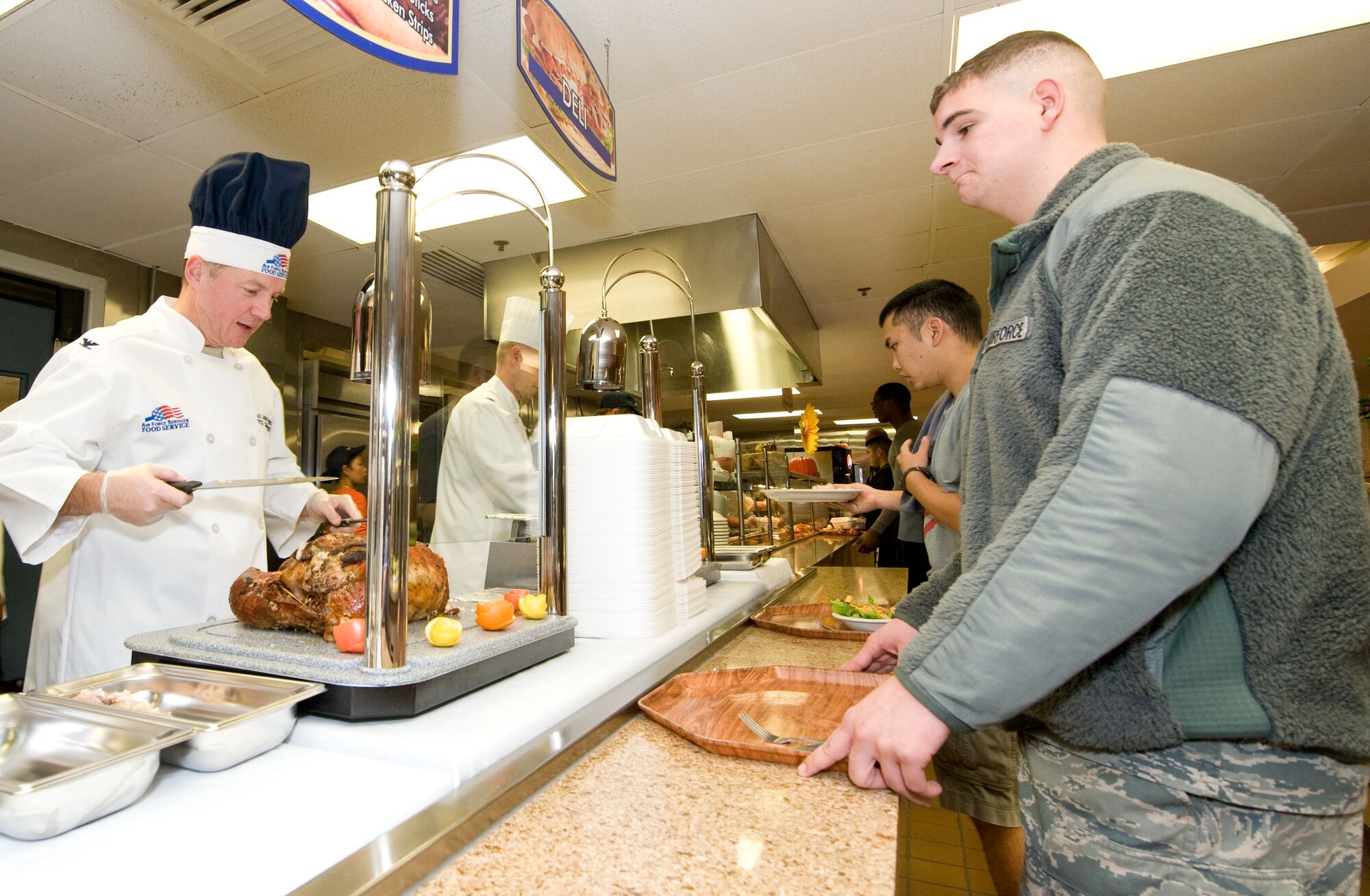 Col. Cal Mercer (left), 436th Airlift Wing vice commander, serves turkey to Airman 1st Class Paul Nadeau of the 436th Operations Support Squadron Nov. 22, 2012, at the Patterson Dining Facility on Dover Air Force Base, Del. Senior leadership spent time serving Thanksgiving meals to the Airmen to recognize their service on the holiday. (U.S. Air Force photo by Greg L. Davis)