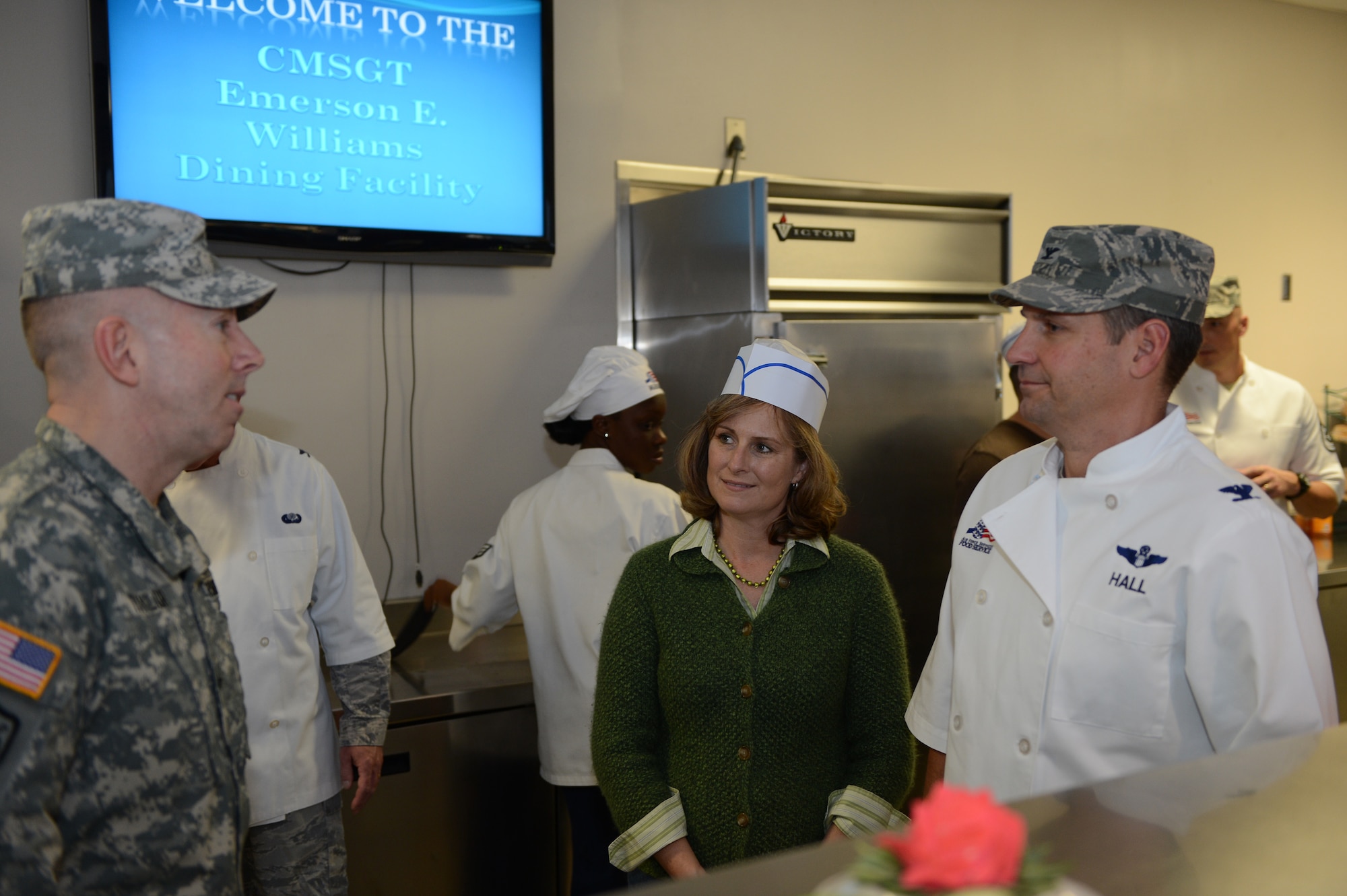 (From left) Brig. Gen. Chuck Taylor, Third Army chief of staff, Barrie Hall, spouse of Col. Clay Hall, 20th Fighter Wing commander, and Col. Hall greet one another before serving Team Shaw members Thanksgiving lunch, Shaw Air Force Base, S.C., Nov. 23.  Team Shaw leadership spent Thanksgiving afternoon serving lunch at the dining facility to help celebrate the holiday. (U.S. Air Force photo by Airman 1st Class Daniel Blackwell/Released)