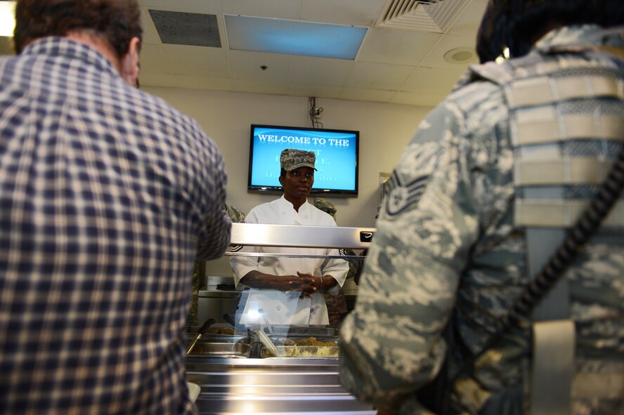 Chief Master Sgt. Juanita Osby, 20th Comptroller Squadron superintendent, prepares to serve Team Shaw members during Thanksgiving lunch at the CMSgt. Emerson E. Williams Dining Facility, Shaw Air Force Base, S.C., Nov. 23, 2012. Team Shaw leadership served lunch at the dining facility to help celebrate Thanksgiving Day. (U.S. Air Force photo by Airman 1st Class Daniel Blackwell/Released)