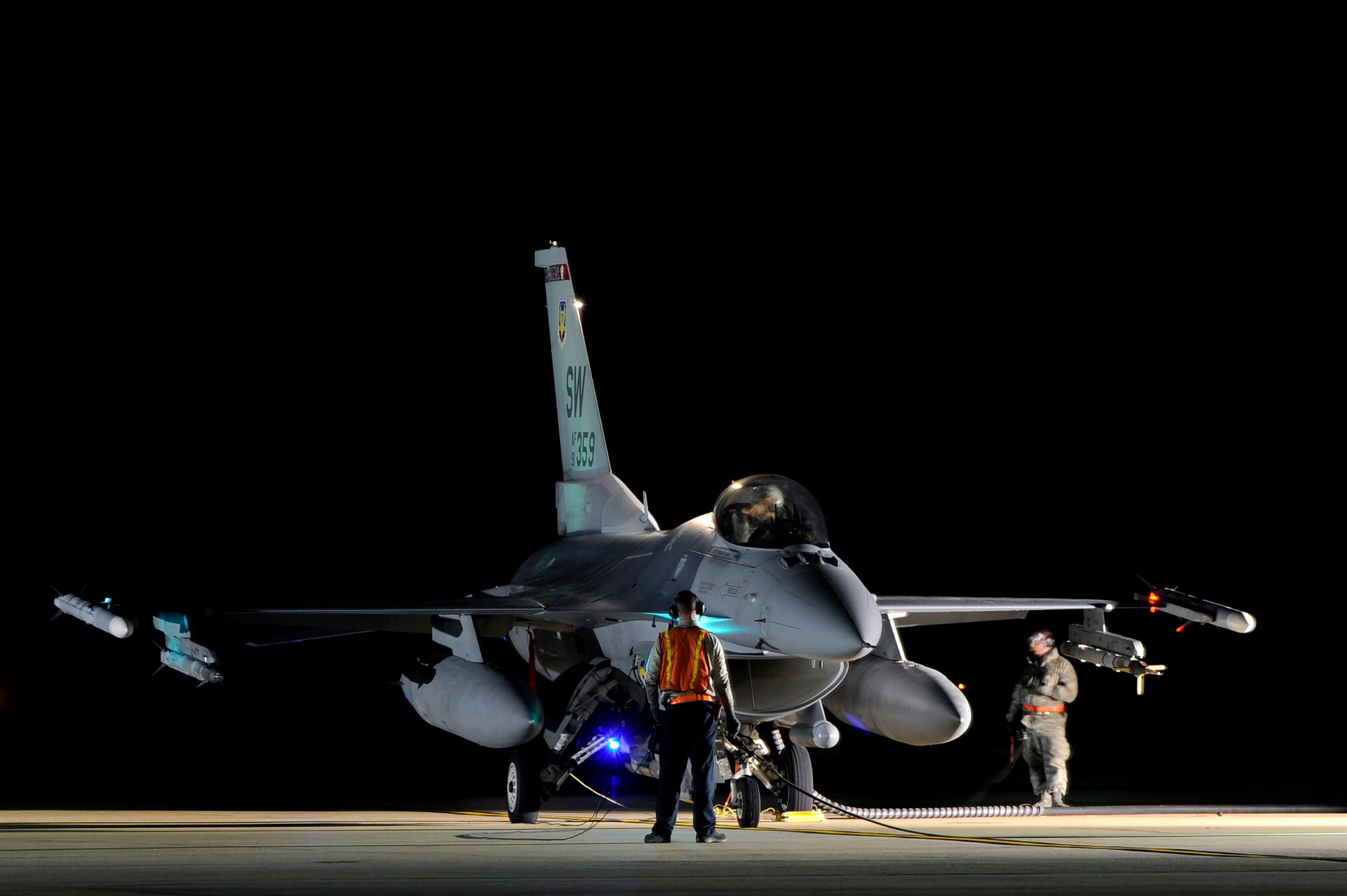 Darkness wraps around two crew chiefs and a U.S. Air Force F-16 Fighting Falcon pilot as a technique called hot pit refueling is performed, Nov. 9, 2012, Shaw Air Force Base, S.C. Hot pit refueling is a procedure usually performed in a combat situation to rapidly refuel aircraft while their engines are running resulting in a speedy refuel to thrust pilots right back into the fight. Airmen assigned to the 20th Logistics Readiness Squadron and 20th Aircraft Maintenance Squadron practice this technique to keep their skills sharp and aid in the effort to provide combat ready air power at a moment’s notice. (U.S. Air Force photo by Staff Sgt. Kenny Holston/Released)