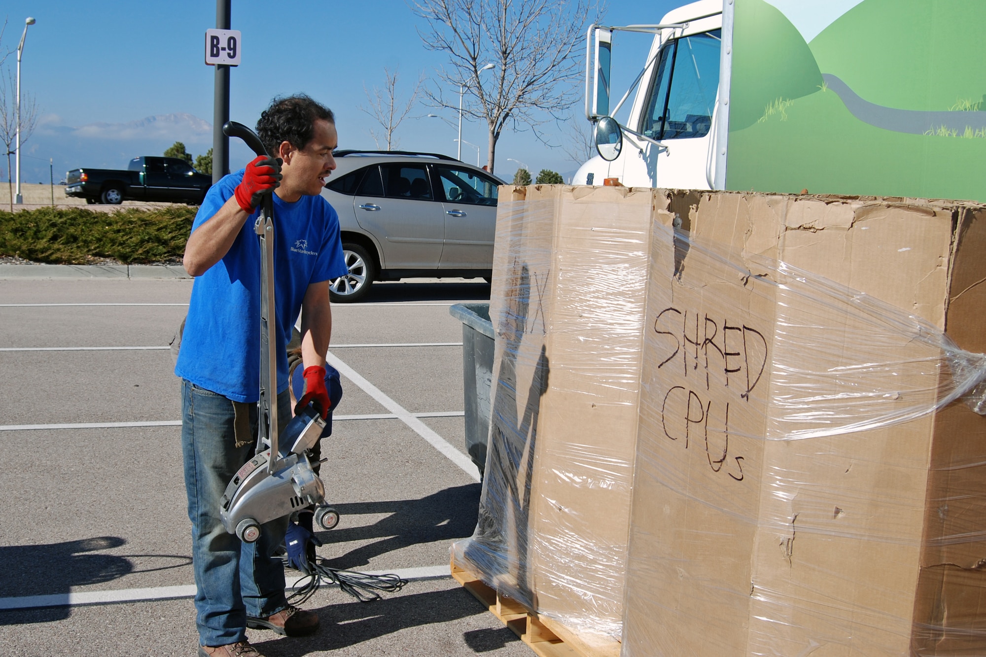 An employee from BlueStar Recyclers sorts a vacuum into the proper recycling bin at The Exchange Nov. 15. The recycling event was part of America Recycles Day. Base users were encouraged to drop off old electronics and appliances for recycling to commemorate the day. In addition to the recycling event, a single stream recycling bin is being installed at building 350 at the end of the month. (U.S. Air Force photo/Lea Johnson)