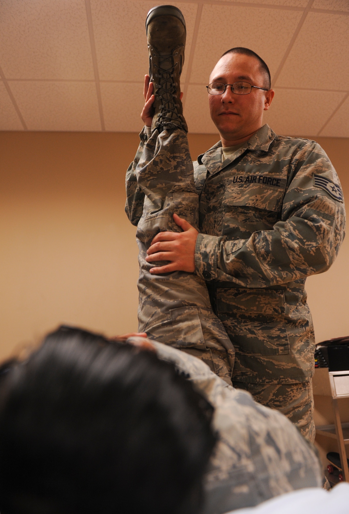 Staff Sgt. David Pienta, a 19th Medical Operations Squadron physical medicine technician, stretches out a patient’s hamstring Nov. 7, 2012, at Little Rock Air Force Base, Ark. Members of the 19th MDOS Physical Therapy Clinic use stretching as a form of treatment. (U.S. Air Force photo by Airman 1st Class Rusty Frank)