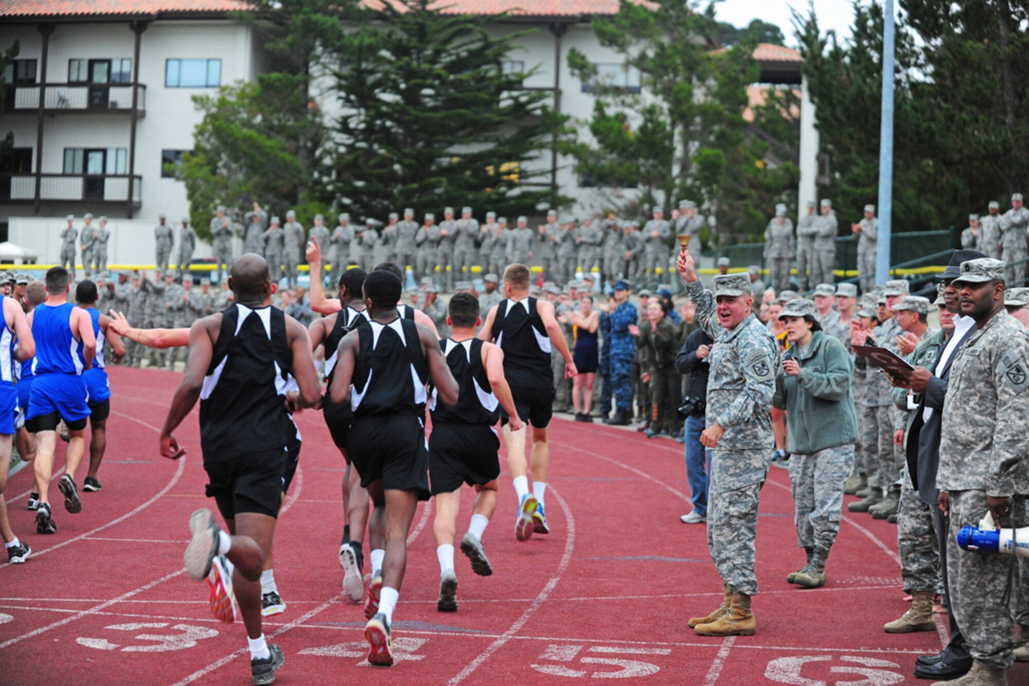 PRESIDIO OF MONTEREY, Calif. - The Defense Language Institute Foreign Language Center's quarterly Commander's Cup running competition was held at the Price Fitness Center track, Nov. 7. In the women's division the Navy seized first place with Marine Corps placing second. In the men's division the results were reversed as the Marine Corps placed first and the Navy second. The Marine Corps had the best combined time and was presented with the Commander's Cup trophy by DLIFLC Commandant Col. Danial Pick. (Courtesy photo)

