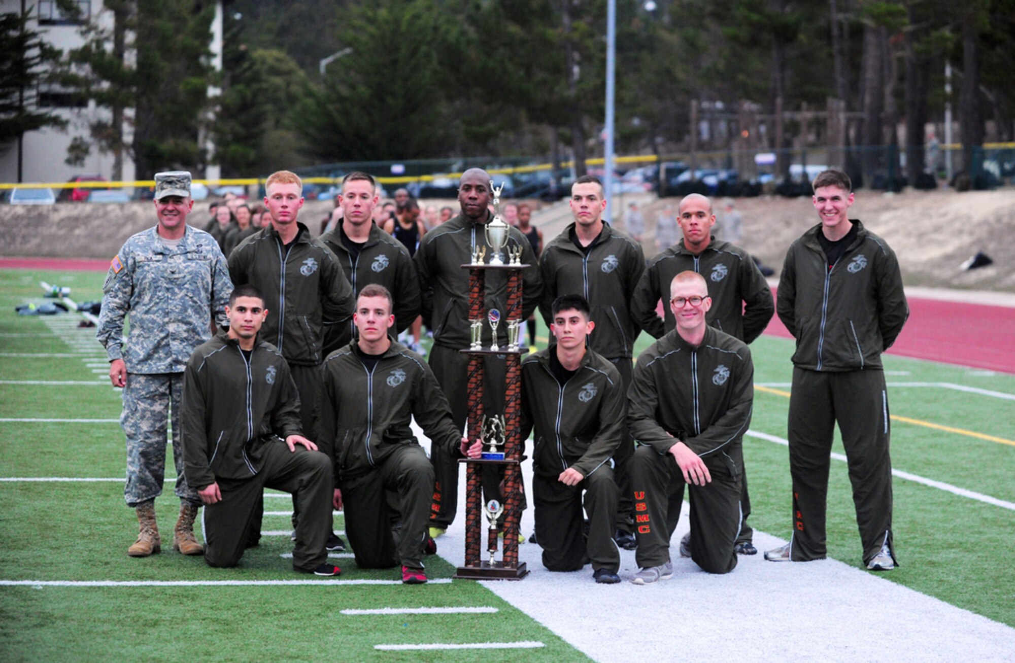 PRESIDIO OF MONTEREY, Calif. - The Defense Language Institute Foreign Language Center's quarterly Commander's Cup running competition was held at the Price Fitness Center track, Nov. 7. In the women's division the Navy seized first place with Marine Corps placing second. In the men's division the results were reversed as the Marine Corps placed first and the Navy second. The Marine Corps had the best combined time and was presented with the Commander's Cup trophy by DLIFLC Commandant Col. Danial Pick. (Courtesy photo)

