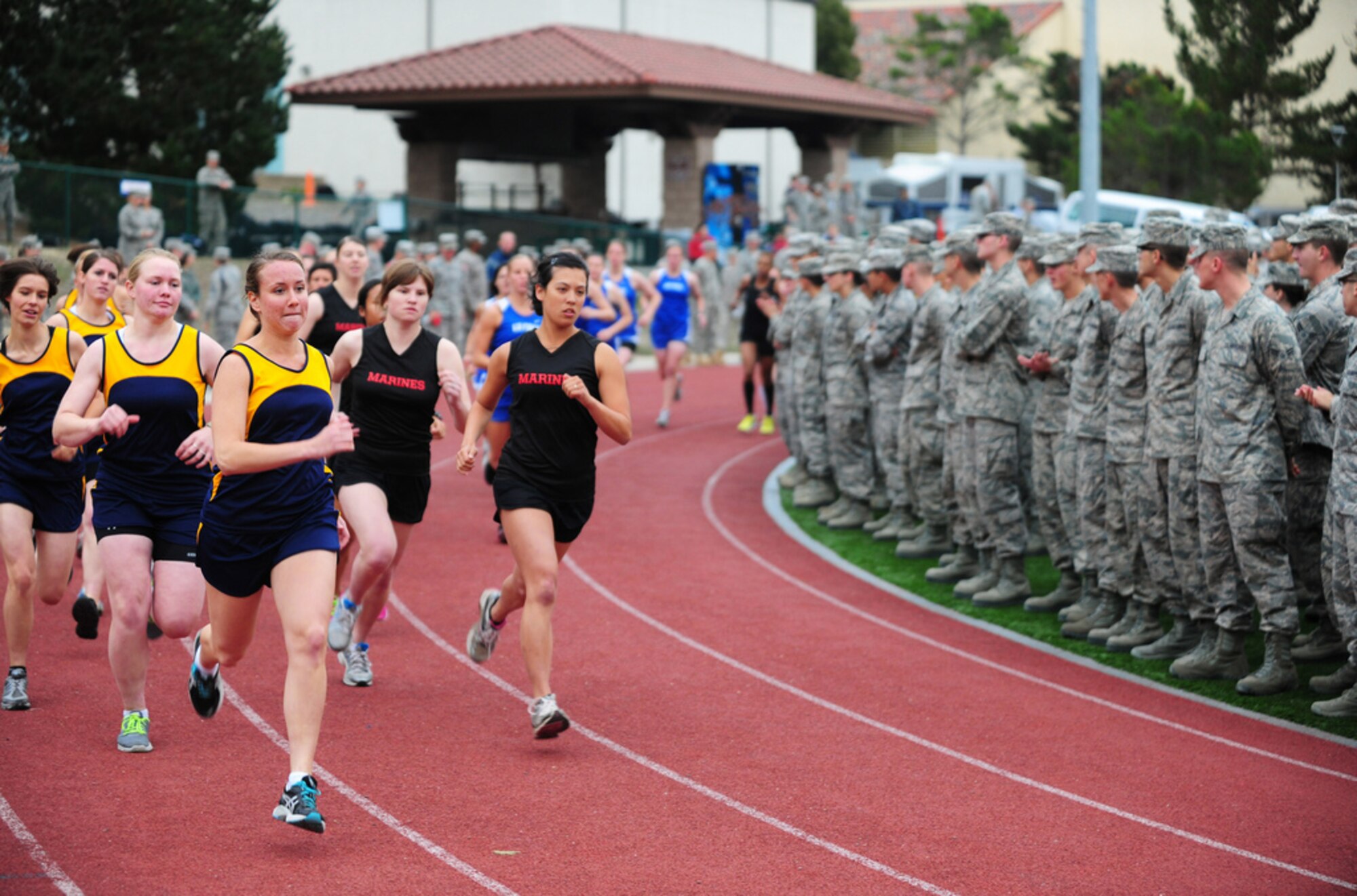 PRESIDIO OF MONTEREY, Calif. - The Defense Language Institute Foreign Language Center's quarterly Commander's Cup running competition was held at the Price Fitness Center track, Nov. 7. In the women's division the Navy seized first place with Marine Corps placing second. In the men's division the results were reversed as the Marine Corps placed first and the Navy second. The Marine Corps had the best combined time and was presented with the Commander's Cup trophy by DLIFLC Commandant Col. Danial Pick. (Courtesy photo)


