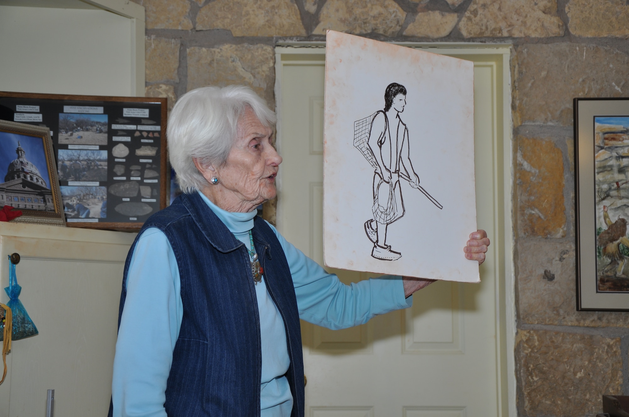 PAINT ROCK, Texas – Kay Campbell, Paint Rock tour guide, presents a painting at Paint Rock Nov. 24. This was part of a class given before the walking tour to help educate the tour group, consisting of military members and families, about Native American history. (U.S. Air Force Photo/ Airman 1st Class Joshua Edwards)