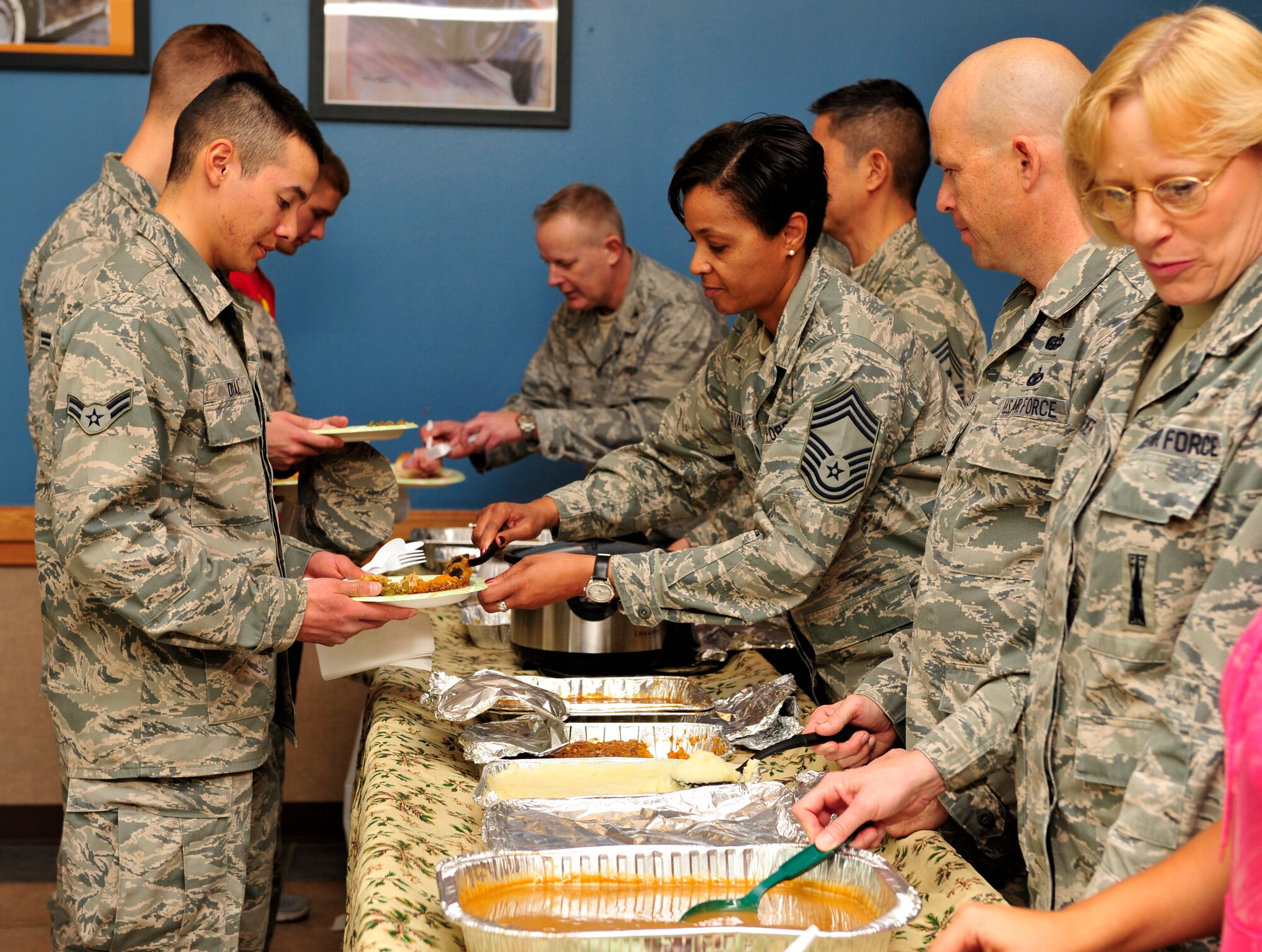 BUCKLEY AIR FORCE BASE, Colo. – Col. Daniel Dant, 460th Space Wing commander, and Chief Master Sgt. Marilyn Savage, 460th Mission Support Group superintendent, alongside other Team Buckley leaders,  serve Thanksgiving dinner to Airmen Nov. 21, 2012, at the Panther Hall Dorm. This is a annual tradition to ensure wellness and show thanks to troops in the dorms. (U.S. Air Force photo by Airman 1st Class Darryl Bolden Jr.)  