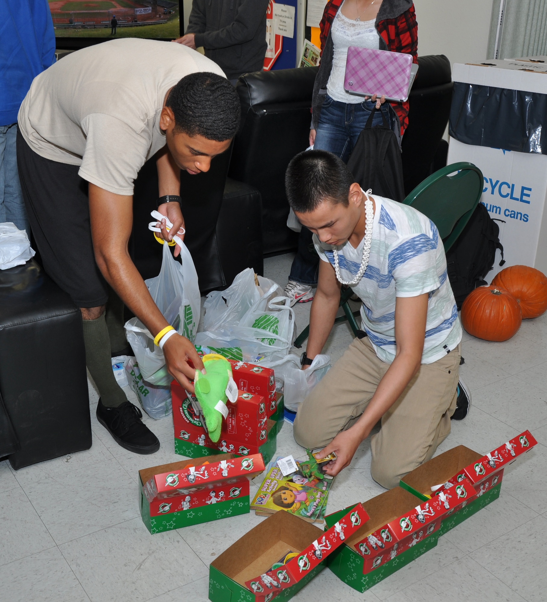 GOODFELLOW AIR FORCE BASE, Texas – Airman Basic Tyler Thomason, 316th Training Squadron student, and Airman Basic Jacob Thomason, 316th Training Squadron student, pack gift boxes for Operation Christmas Child at the Crossroads Student Center here Nov. 18.  Operation Christmas Child is a charity event in which gifts are sent out to more than 130 countries to needy children. (U.S. Air Force photo/ Airman 1st Class Joshua Edwards)