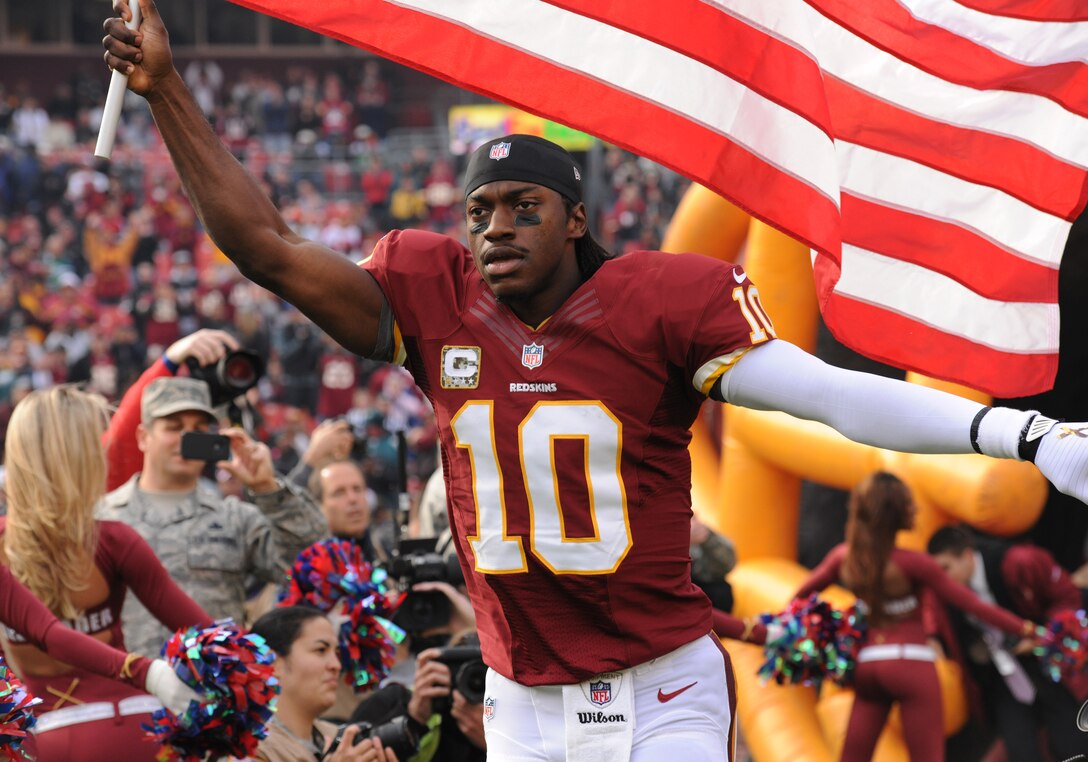 Washington Redskins quarterback Robert Griffin III, runs onto the field before the start of the military appreciation game at FedEx Field in Landover, Md., Nov. 18, 2012. Air Force District of Washington Airmen were honored for their service by the National Football League and the Washington Redskins as part of USAA's "Salute to Service."(U.S. Air Force photo/Airman 1st Class Erin O’Shea)