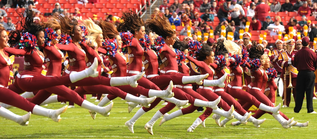Washington Redskins cheerleaders jump into the splits at the military appreciation game at FedEx Field, in Landover, Md., Nov. 18, 2012. More than 25 Air Force District of Washington Airmen were selected to be honored for their service by the National Football League and the Washington Redskins as part of United Serviceman's Automobile Association's, "Salute to Service."(U.S. Air Force photo/Airman 1st Class Erin O’Shea)
