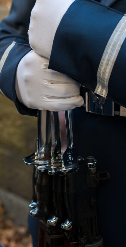 An Airman from the U.S. Air Force Honor Guard holds his fellow Airmen's rifles while they check over each others uniforms prior to the start of the 86th Annual Macy's Thanksgiving Day Parade, Nov. 22, 2012, in New York City. Two hundred Airmen from the USAF Band and Honor Guard marched in the parade with a televised audience of 55 million viewers and live audience of more than three million spectators. (U.S. Air Force photo by Senior Airman Perry Aston)
