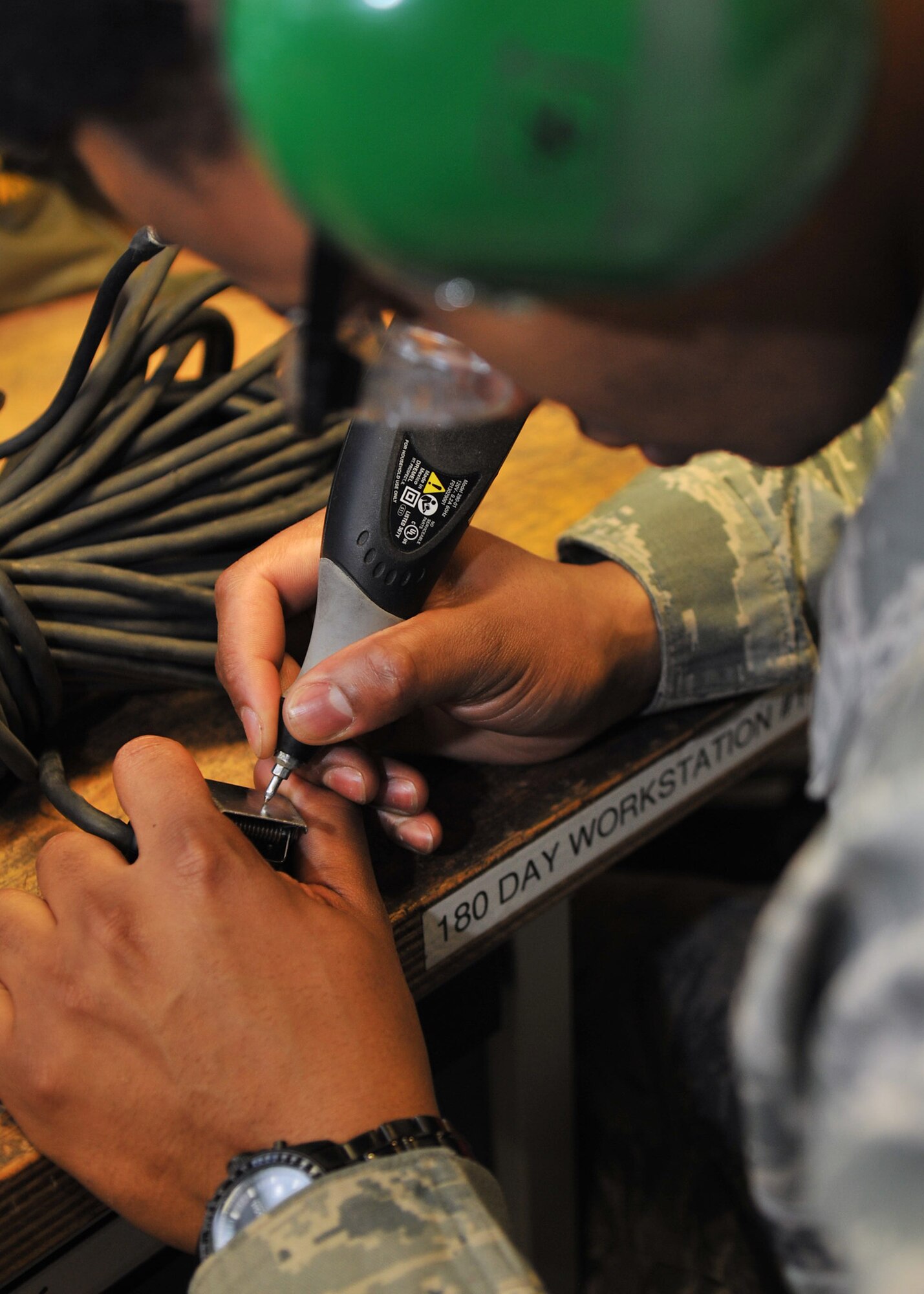 Staff Sgt. Jamie Harrington, 100th Aircraft Maintenance Squadron maintenance sortie support craftsman, re-etches a communication cord Nov. 27, 2012, at RAF Mildenhall, England. The sortie support section manages all tools and test equipment for the 100th Maintenance Group. (U.S. Air Force photo by Senior Airman Jerilyn Quintanilla/Released)