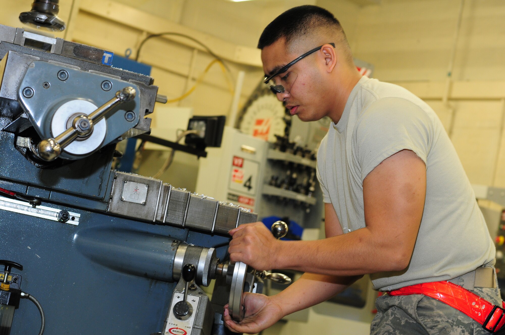 ROYAL AIR FORCE LAKENHEATH, England – Senior Airman Wendel Garcia, 48th Equipment Maintenance Squadron metals technology journeyman, operates a manual milling machine to shave down metal equipment Nov. 20, 2012. The 48th EMS metals technology shop’s mission is to function as the U.S. Air Force’s welders by fabricating or repairing aircraft and ground equipment components. (U.S. Air Force photo by Airman 1st Class Cory D. Payne)